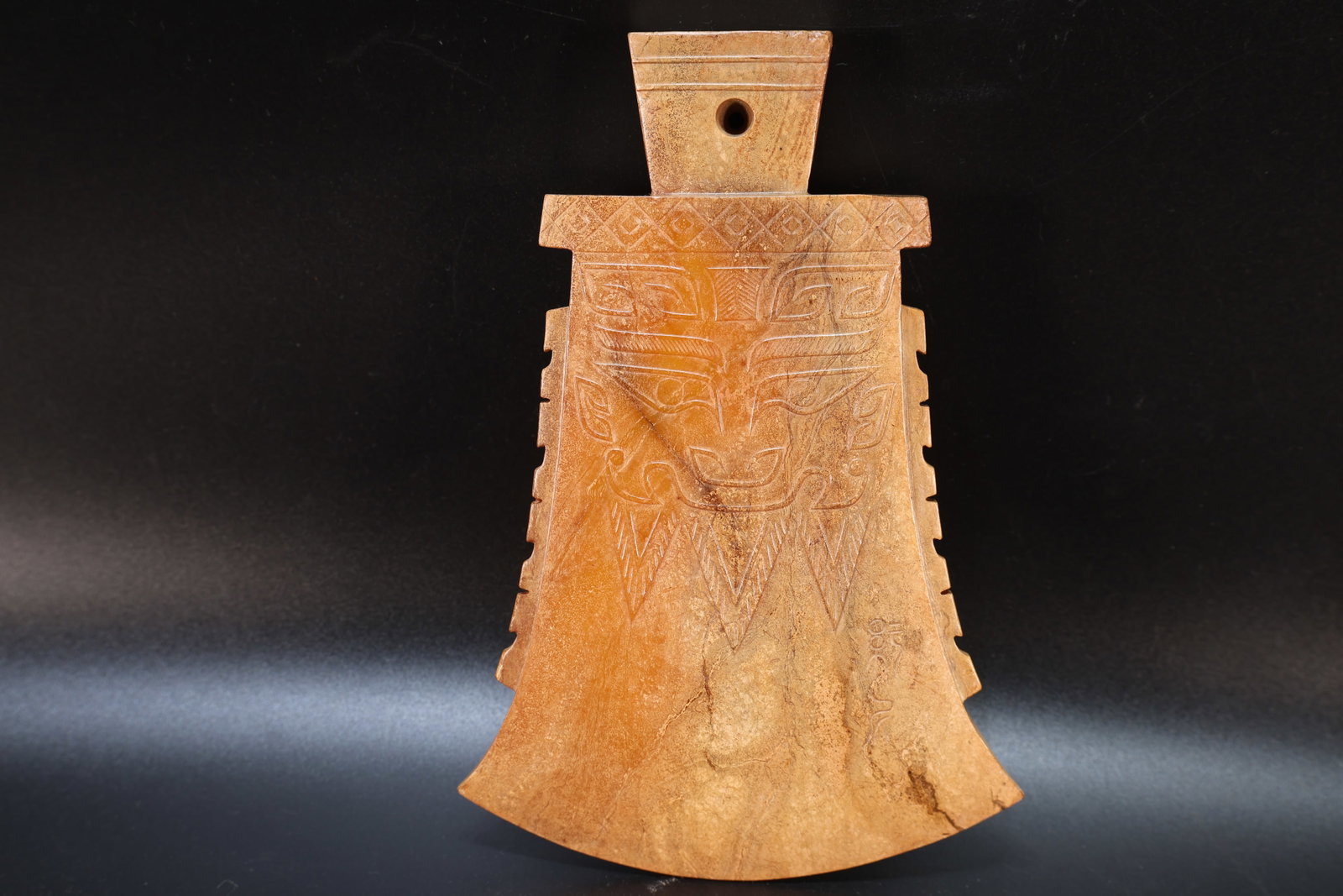 A Jade Carved Beast Face Pattern Axe: A Jade Carved Beast Face Pattern Axe (17 x 11.5 x 1.6cm)