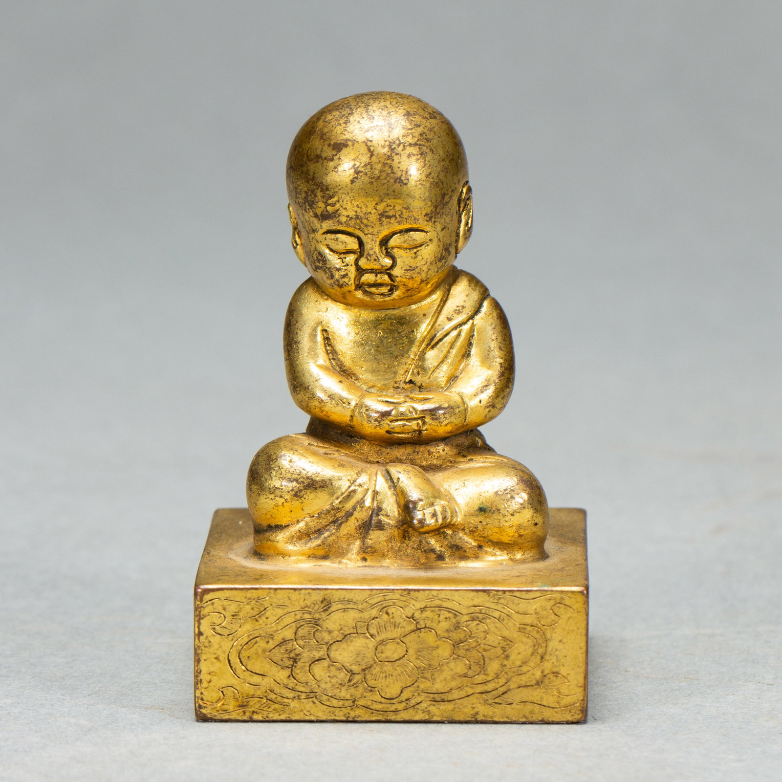A Chinese Gilt Bronze Seal with Seated Monk Finial: A Chinese Gilt Bronze Seal with Seated Monk Finial (4 x 4 x 6.5cm,Weight 300g)