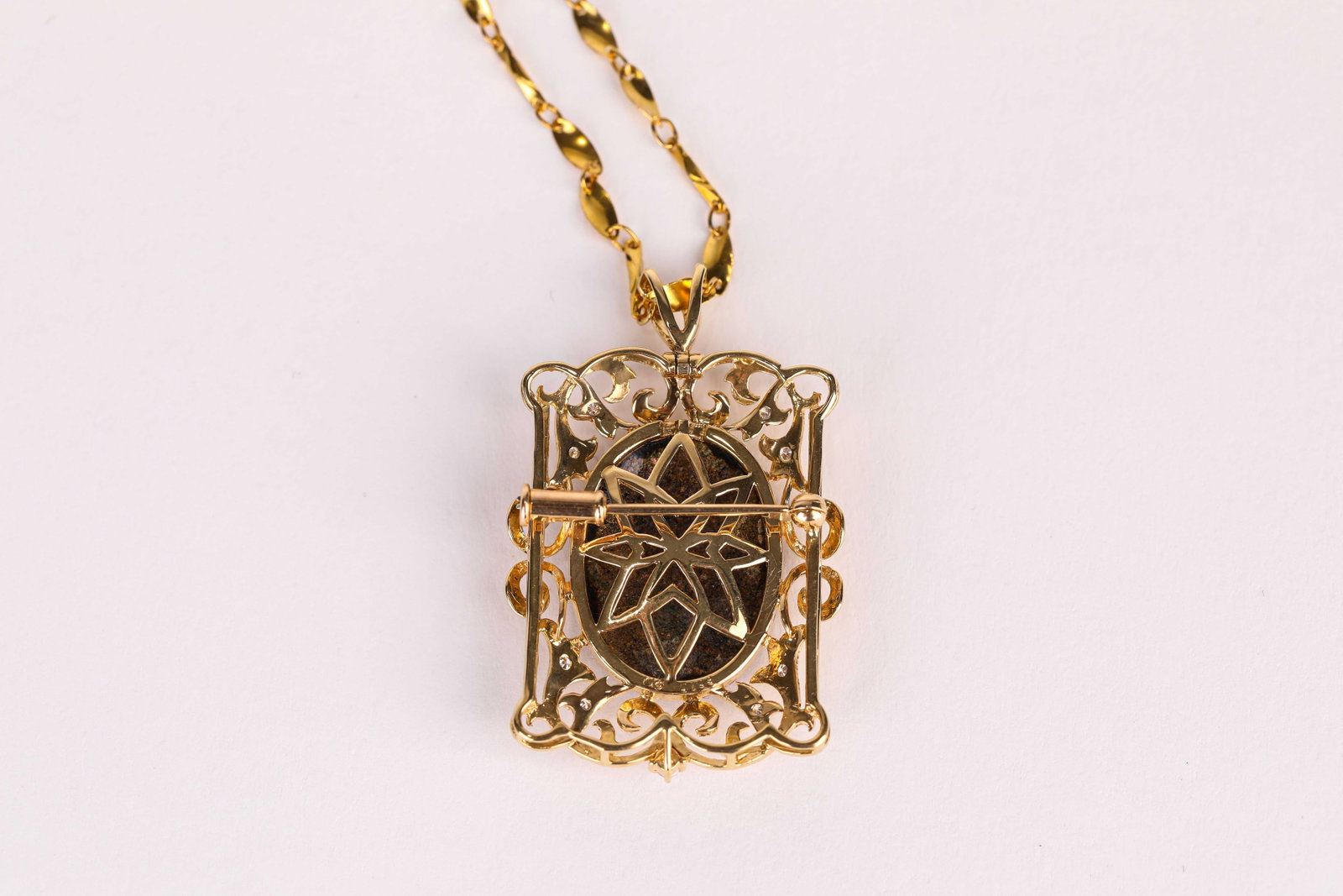 A Gold, Enamel and Diamond 'Figural' Brooch Pendant: Dimensions: Weight: 10 g. Width: 2.5 cm x Height: 3.3 cm. All measurements are approximate.