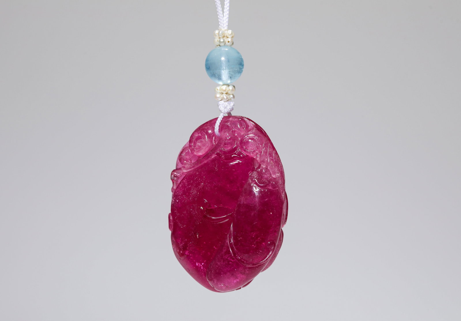 A Tourmaline Pendant: Dimensions: Length: 3.2 cm x Width: 1.5 cm x Height: 4.5 cm. All measurements are approximate.