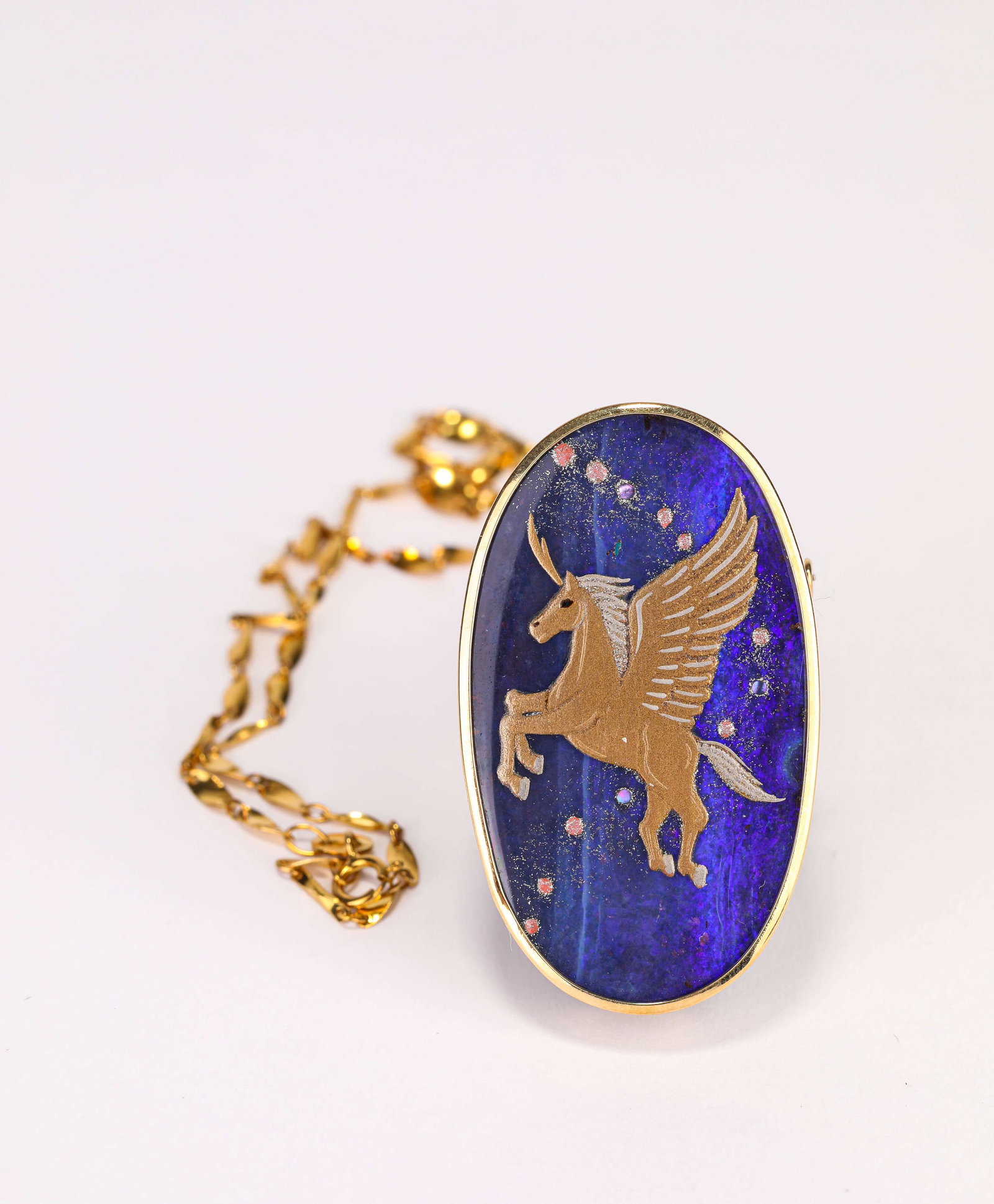 A Lapis Lazuli Brooch and Gold Necklace: Dimensions: Weight: 18 g. Width: 2.8 cm x Height: 4.6 cm. All measurements are approximate.