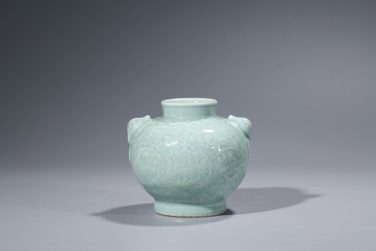 A Celadon-Glazed 'Relief-Decorated' Jar: Dimensions: Length: 13.9 cm x Width: 13.4 cm x Height: 12.5 cm. All measurements are approximate.
