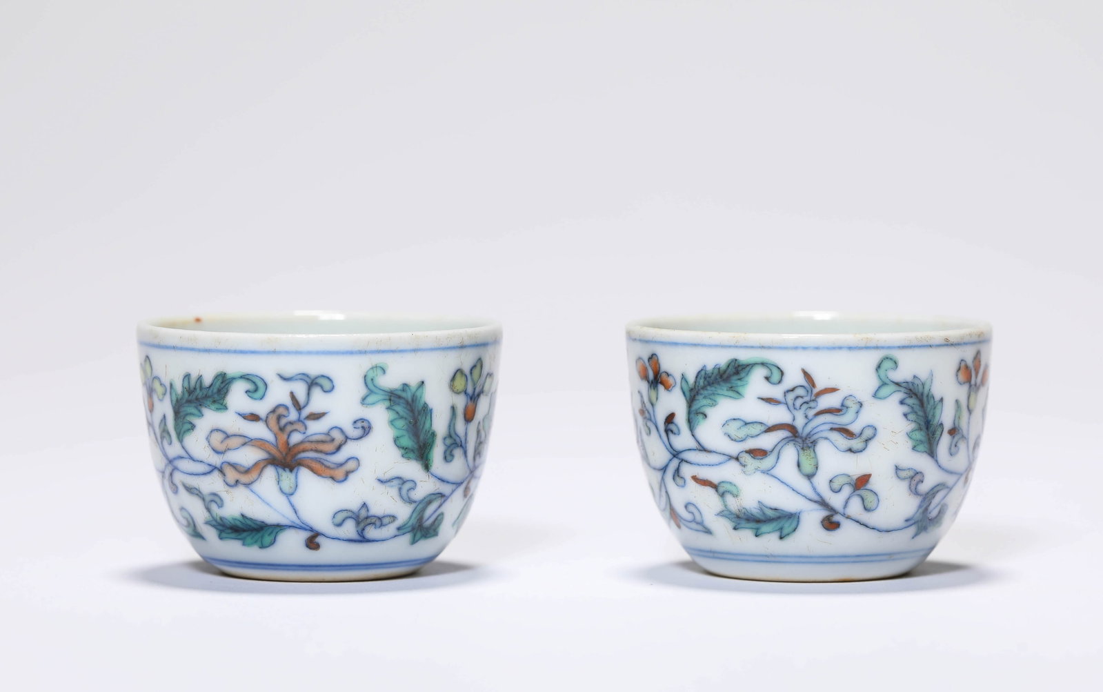 A PAIR OF DOUCAI ?INTERLOCKING FLORALS? CUPS: A PAIR OF DOUCAI ?INTERLOCKING FLORALS? CUPS Description: Dimensions: Width: 3.7 cm x Height: 2.4 cm. All measurements are approximate.