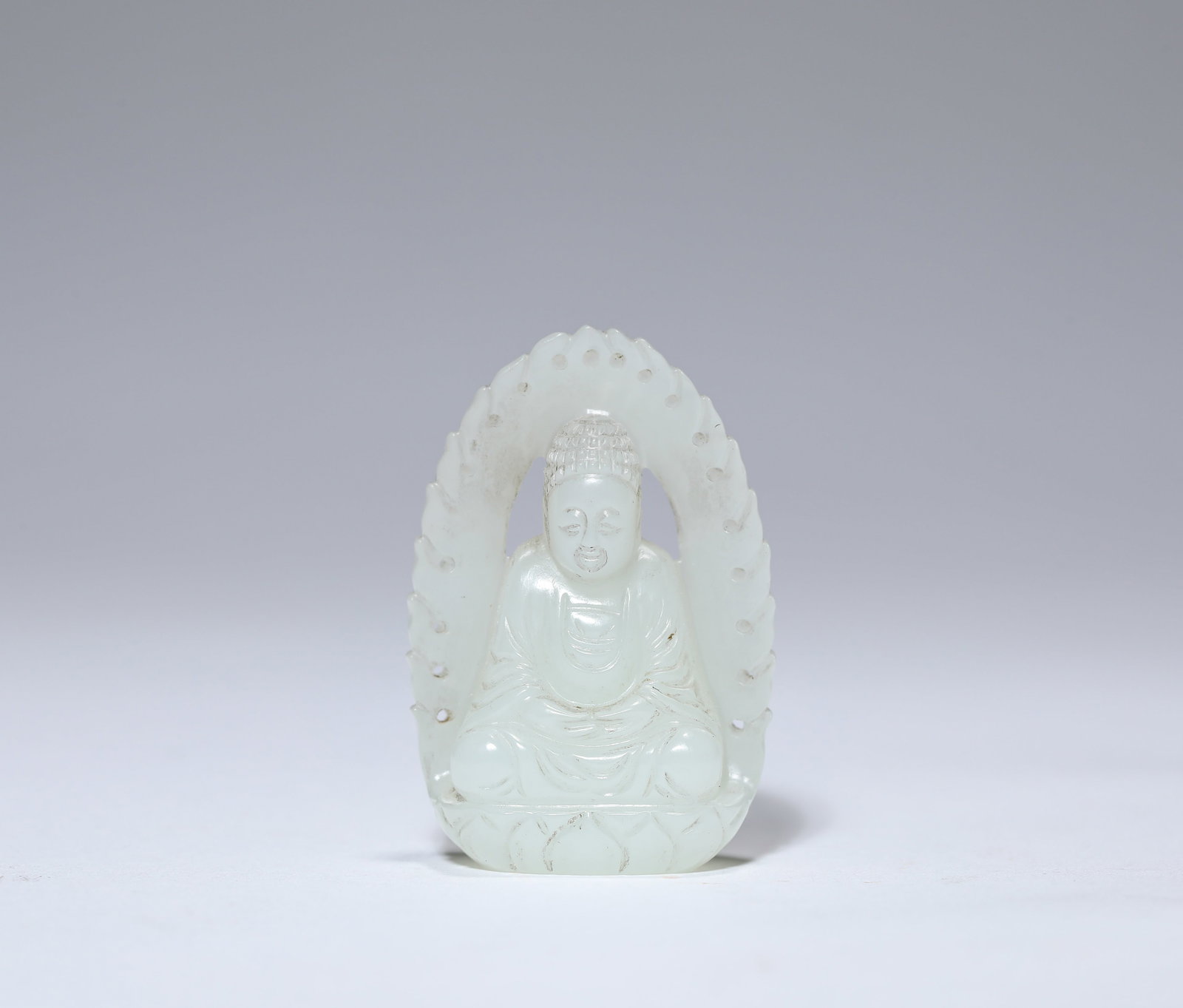 A JADE FIGURE OF SHAKYAMUNI: A JADE FIGURE OF SHAKYAMUNI Description: Dimensions: Length: 2.8 cm x Width: 1.4 cm x Height: 4 cm. All measurements are approximate.