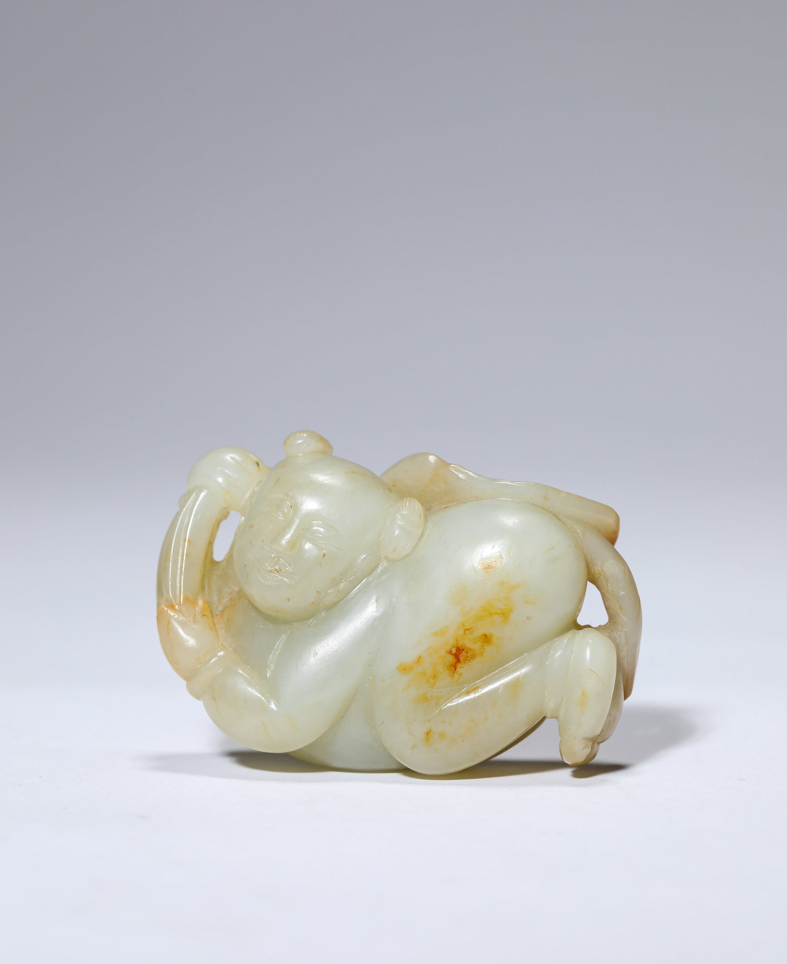 A JADE FIGURE OF A BOY: A JADE FIGURE OF A BOY Description: Dimensions: Length: 5.8 cm x Width: 2 cm x Height: 3.9 cm. All measurements are approximate.