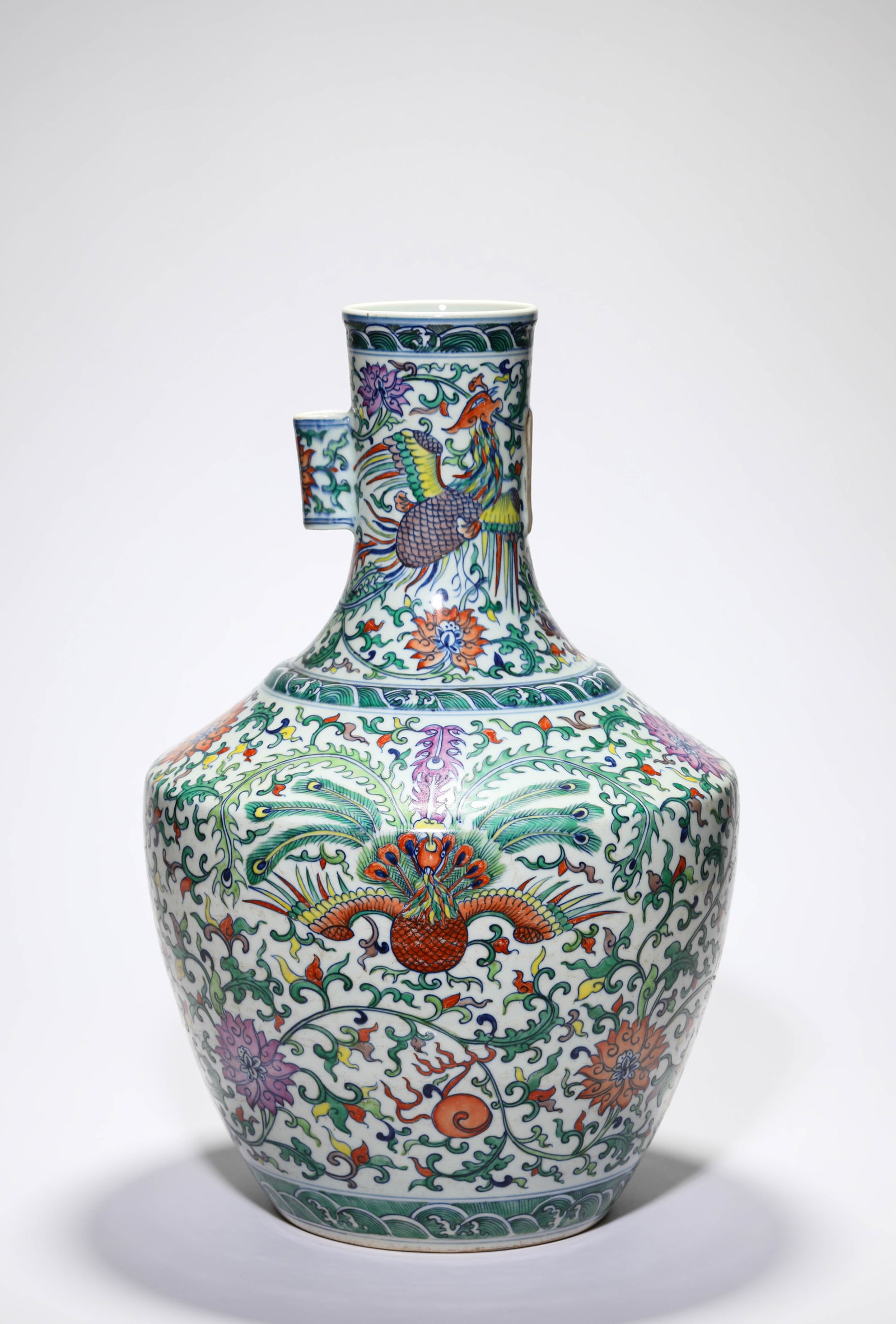 A DOUCAI ?PHOENIX AND PEACOCK? VASE WITH ?TUBE HANDLES?: A DOUCAI ?PHOENIX AND PEACOCK? VASE WITH ?TUBE HANDLES? Description: Dimensions: Width: 31.1 cm x Height: 47.5 cm. All measurements are approximate.