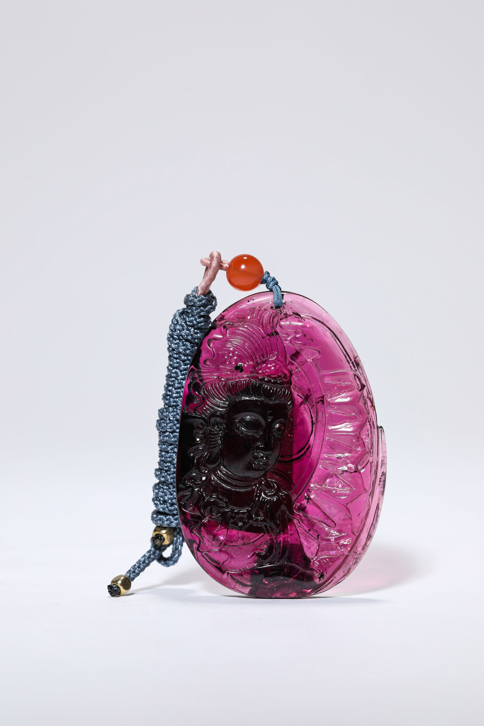 A TOURMALINE ?CARVED BUDDHA? PLAQUE: A TOURMALINE ?CARVED BUDDHA? PLAQUE Description: Dimensions: Width: 3.8 cm x Height: 5.5 cm. All measurements are approximate.