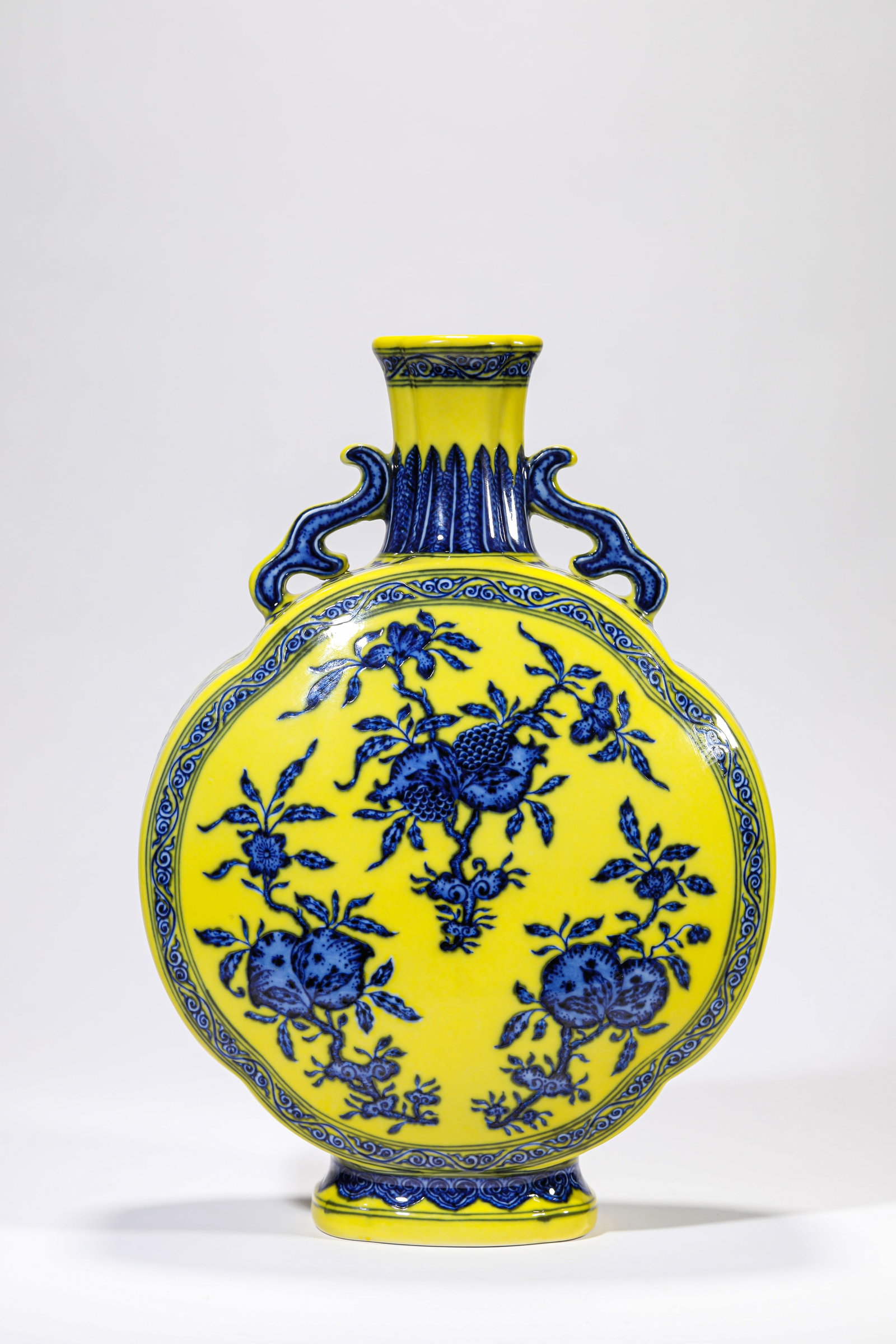 A YELLOW-GROUND BLUE AND WHITE ?THREE ABUNDANCES? ?MOONFLASK?: A YELLOW-GROUND BLUE AND WHITE ?THREE ABUNDANCES? ?MOONFLASK? Description: Dimensions: Length: 23.8 cm x Width: 12 cm x Height: 34 cm. All measurements are approximate.