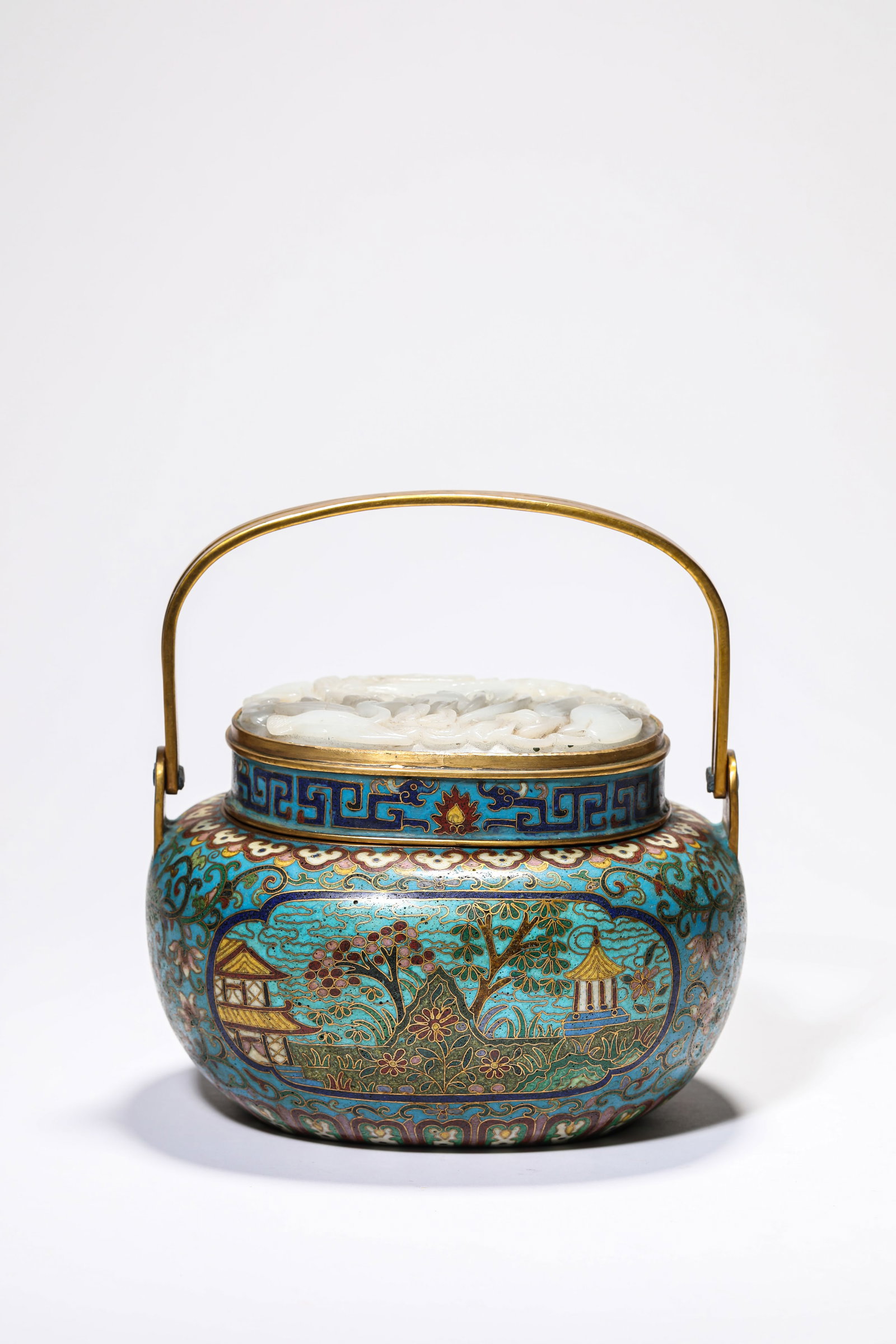 A CLOISONN‚ ENAMEL AND JADE-INLAID ?LANDSCAPE RESERVES? HAND WARMER: A CLOISONN‚ ENAMEL AND JADE-INLAID ?LANDSCAPE RESERVES? HAND WARMER Description: Dimensions: Weight: 1457 g. Length: 16.6 cm x Width: 14.4 cm x Height: 17.3 cm. All measurements are approximate.
