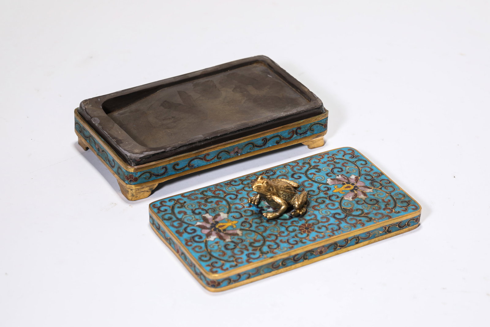 A CLOISONN‚ ENAMEL ?FLORAL? ?TOAD-FORM FINIAL? INKSTONE: A CLOISONN‚ ENAMEL ?FLORAL? ?TOAD-FORM FINIAL? INKSTONE Description: Dimensions: Weight: 800 g. Length: 14 cm x Width: 8 cm x Height: 6 cm. All measurements are approximate.