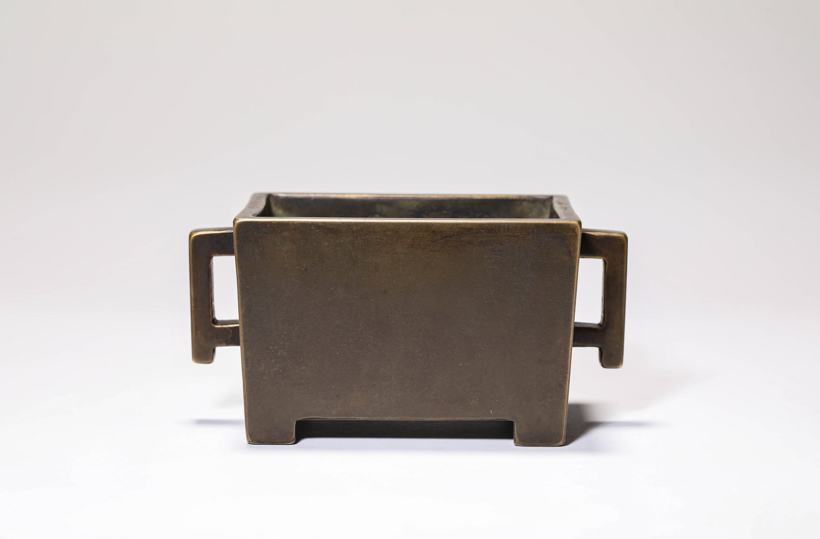 A BRONZE ?TROUGH-FORM? CENSER: A BRONZE ?TROUGH-FORM? CENSER Description: Dimensions: Weight: 1329 g. Length: 14.5 cm x Width: 8.9 cm x Height: 7.3 cm. All measurements are approximate.