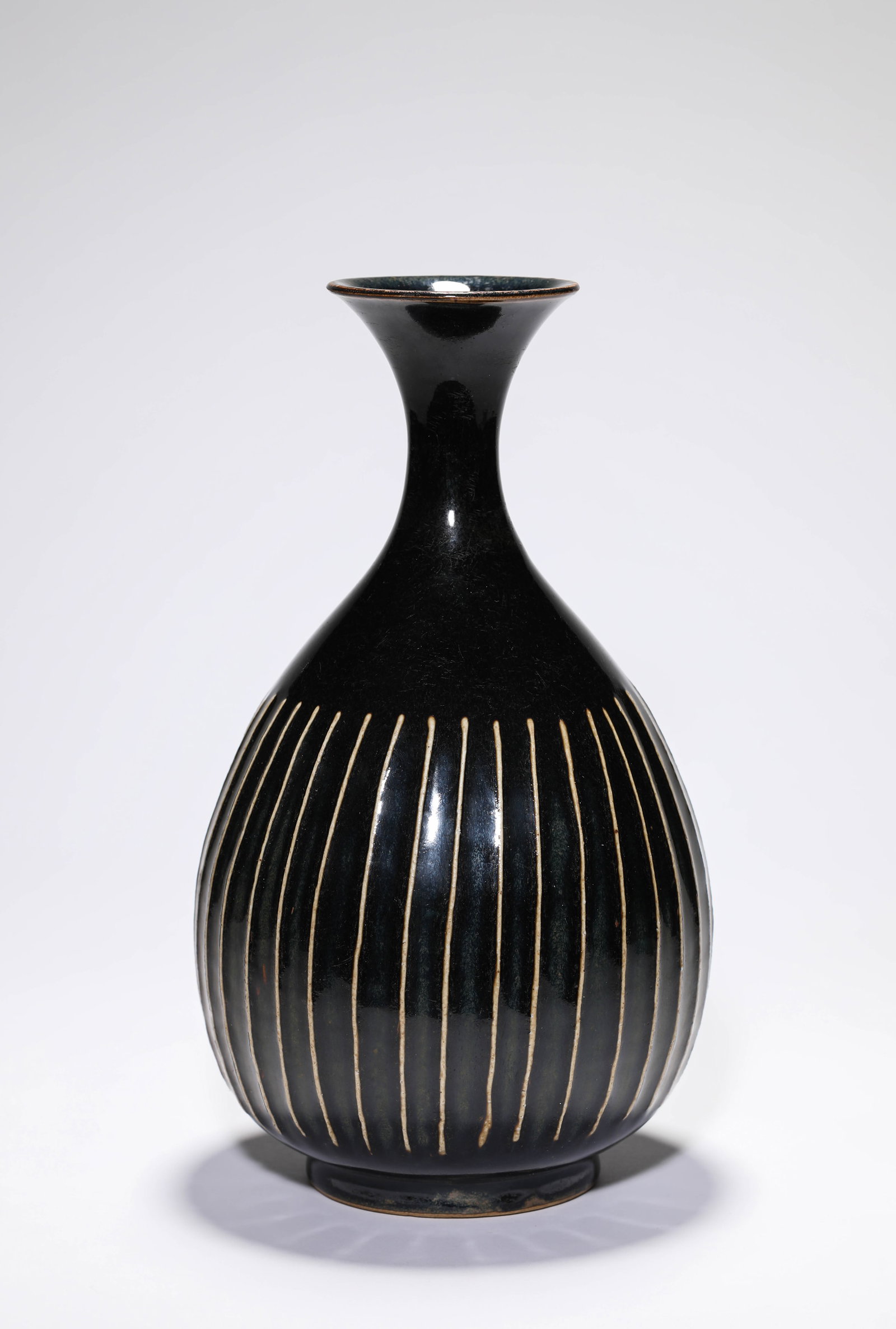 A BLACK-GLAZED ?MELON-LOBED? YUHUCHUN: A BLACK-GLAZED ?MELON-LOBED? YUHUCHUN Description: Dimensions: Width: 16.9 cm x Height: 29.6 cm. All measurements are approximate.