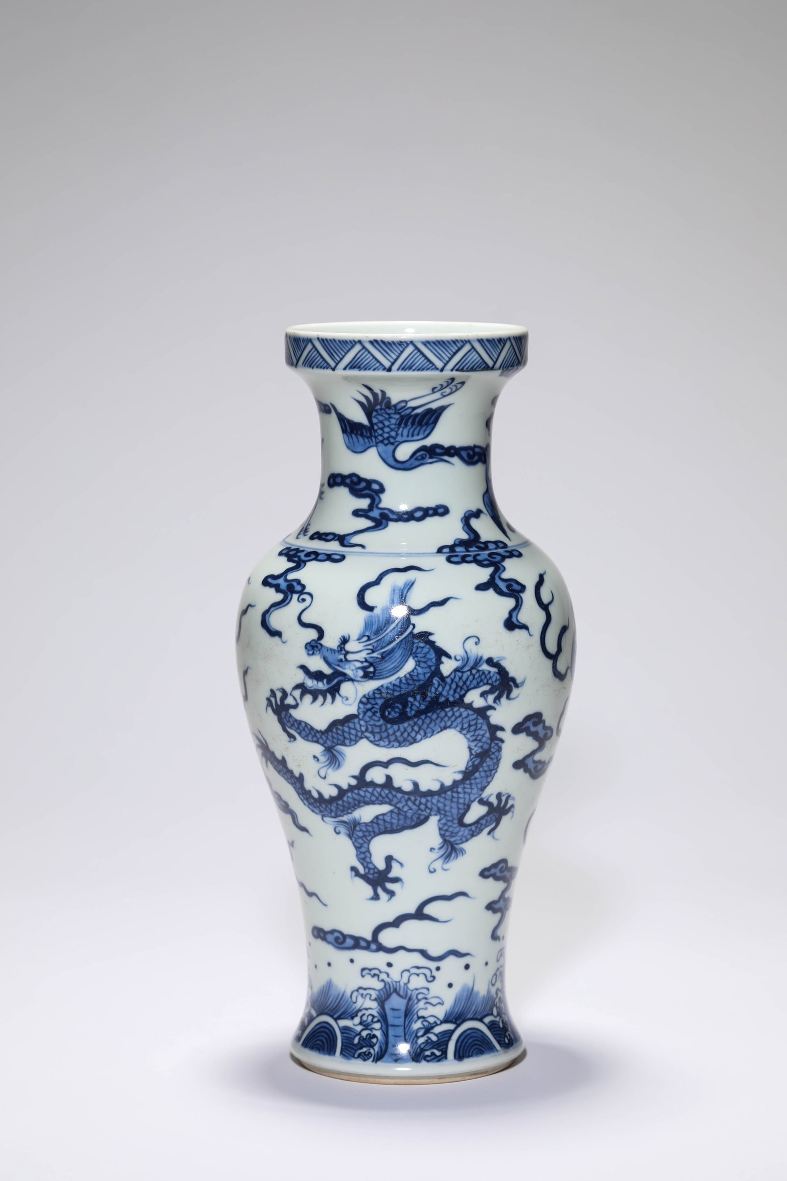A BLUE AND WHITE ?TWO DRAGONS CHASING A PEARL AMIDST WAVES? ?DISH-MOUTH? VASE: A BLUE AND WHITE ?TWO DRAGONS CHASING A PEARL AMIDST WAVES? ?DISH-MOUTH? VASE Description: Dimensions: Width: 12.2 cm x Height: 26.4 cm. All measurements are approximate.