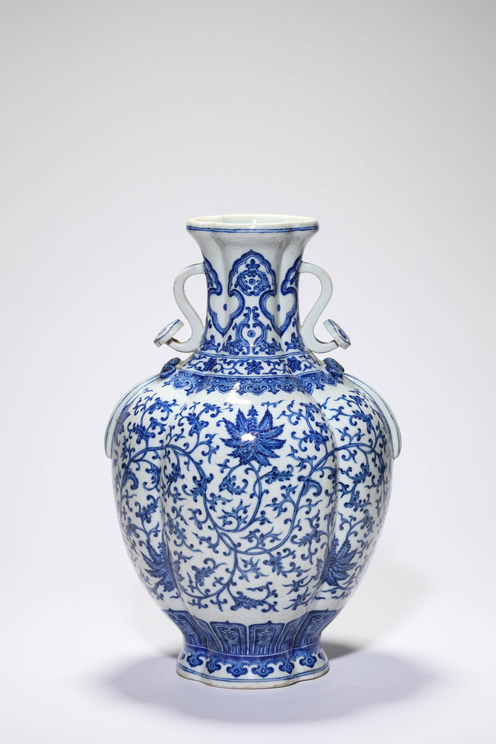 A BLUE AND WHITE ?INTERLOCKING FLORALS? ?MELON-LOBED? VASE: A BLUE AND WHITE ?INTERLOCKING FLORALS? ?MELON-LOBED? VASE Description: Dimensions: Width: 20.1 cm x Height: 34 cm. All measurements are approximate.