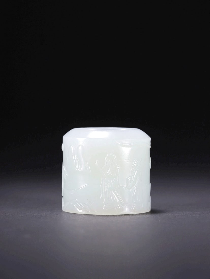 A HETIAN JADE ARCHER'S RING WITH FIGURE MOTIFS: A HETIAN JADE ARCHER'S RING WITH FIGURE MOTIFS Size:Diam:2.1cm,Height:2.9cm