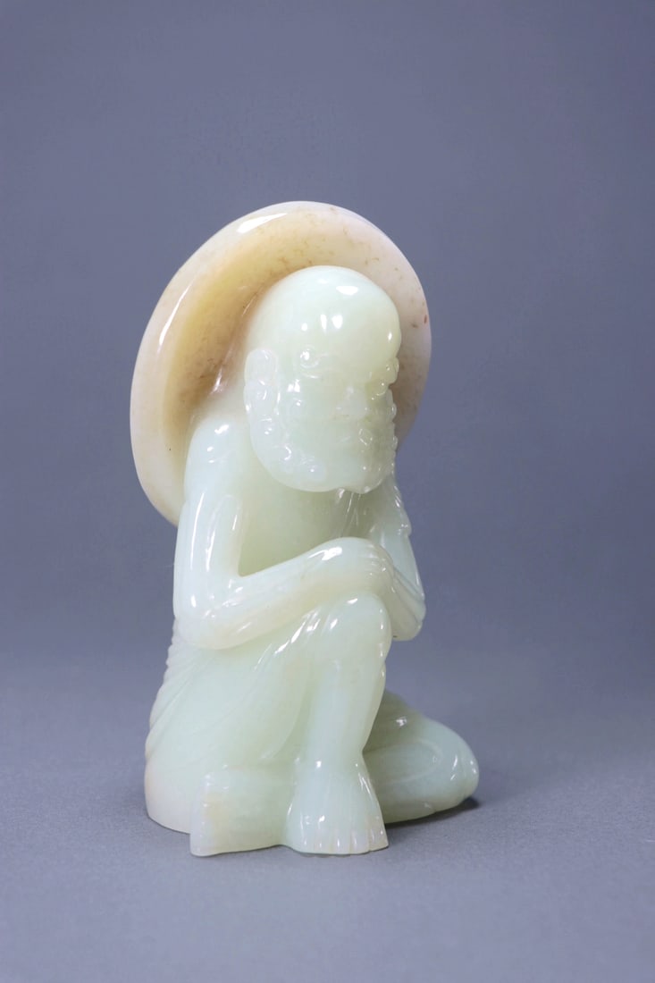 A SEATED HETIAN JADE FIGURE OF BODHIDHARMA: A SEATED HETIAN JADE FIGURE OF BODHIDHARMA Size:Length:7.5cm,Width:6cm,Height:12.5cm;Weight:620grams