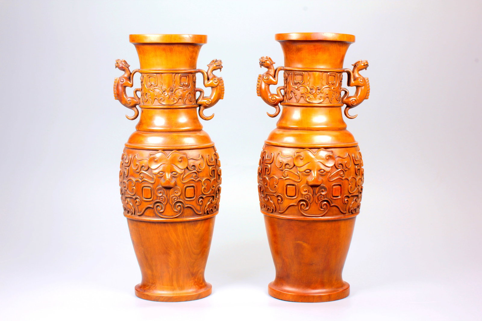 A PAIR OF BOXWOOD VASES WITH TAOTIE MASK MOTIFS AND CHILONG HANDLES: A PAIR OF BOXWOOD VASES WITH TAOTIE MASK MOTIFS AND CHILONG HANDLES Size:Height:29.5cm,Width:12.2cm
