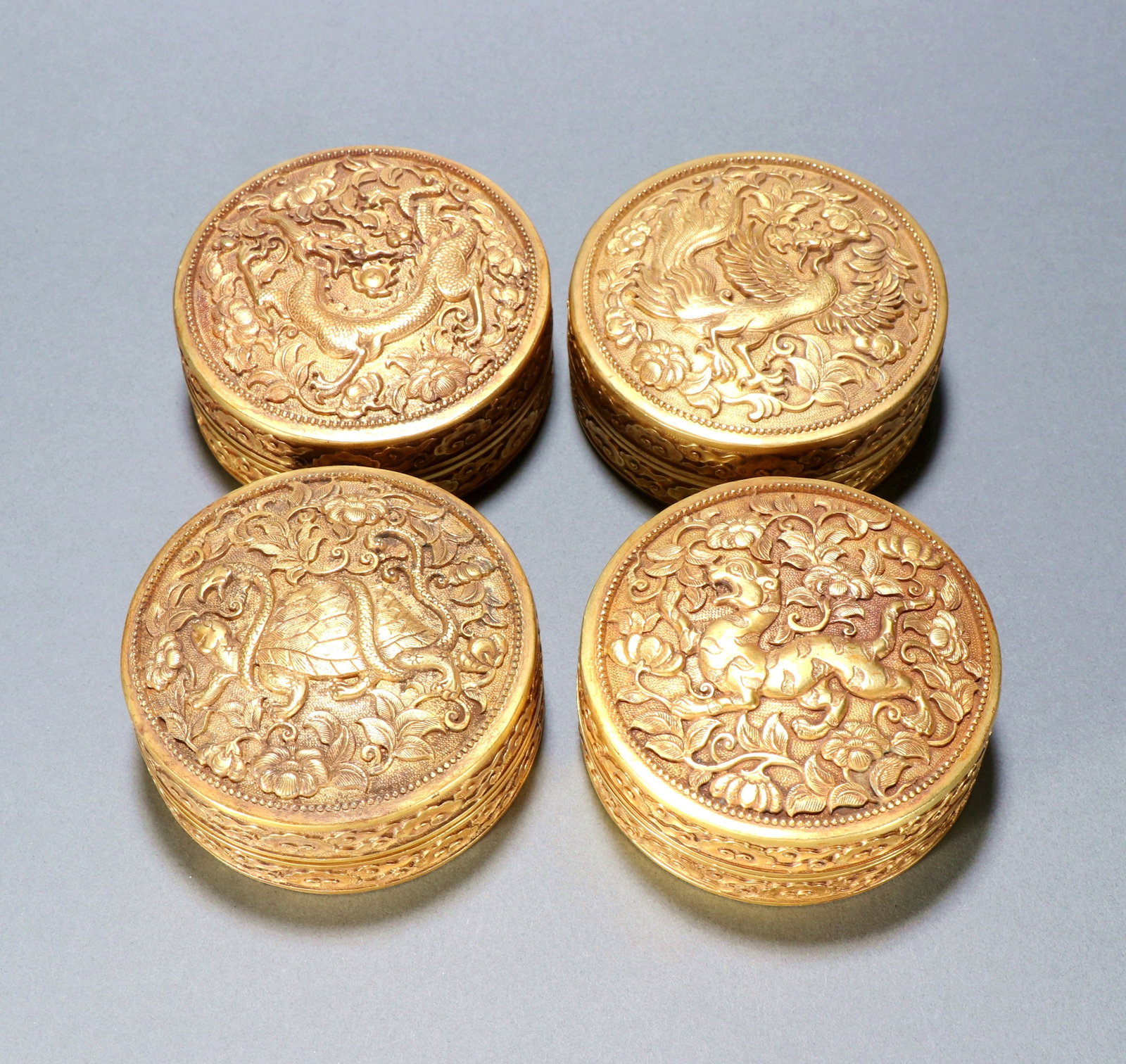 A GILT-BRONZE SET OF FOUR COVERED BOXES WITH 'FOUR DIVINE BEASTS': A GILT-BRONZE SET OF FOUR COVERED BOXES WITH 'FOUR DIVINE BEASTS' Size:Height:3.3cm,Width:8.5cm;Weight:1728grams