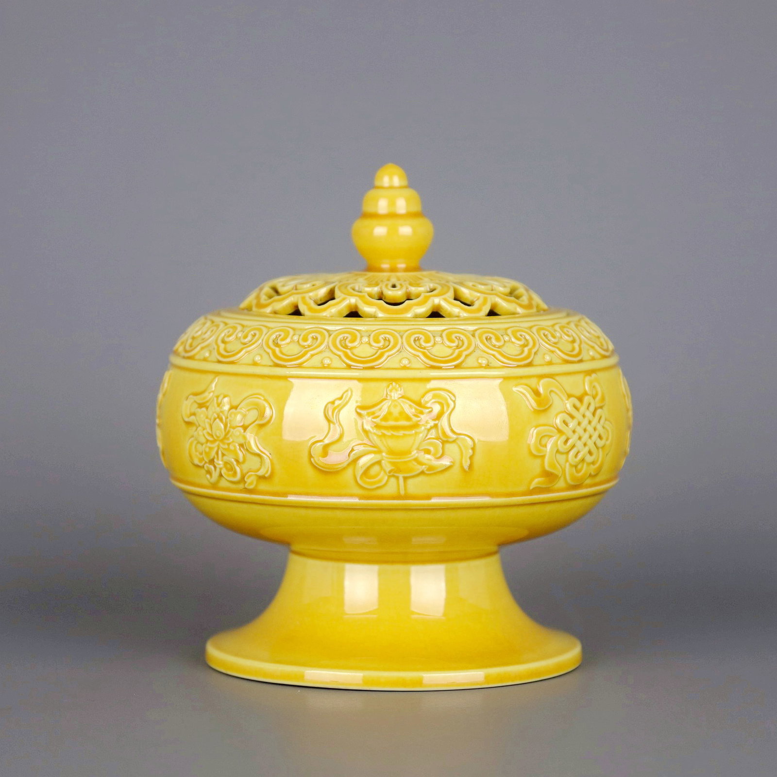A YELLOW GLAZED CARVED RUYI AND EIGHT TREASURES INCENSE BURNER: A YELLOW GLAZED CARVED RUYI AND EIGHT TREASURES INCENSE BURNER Size:Height:11.8cm,Diam:11cm