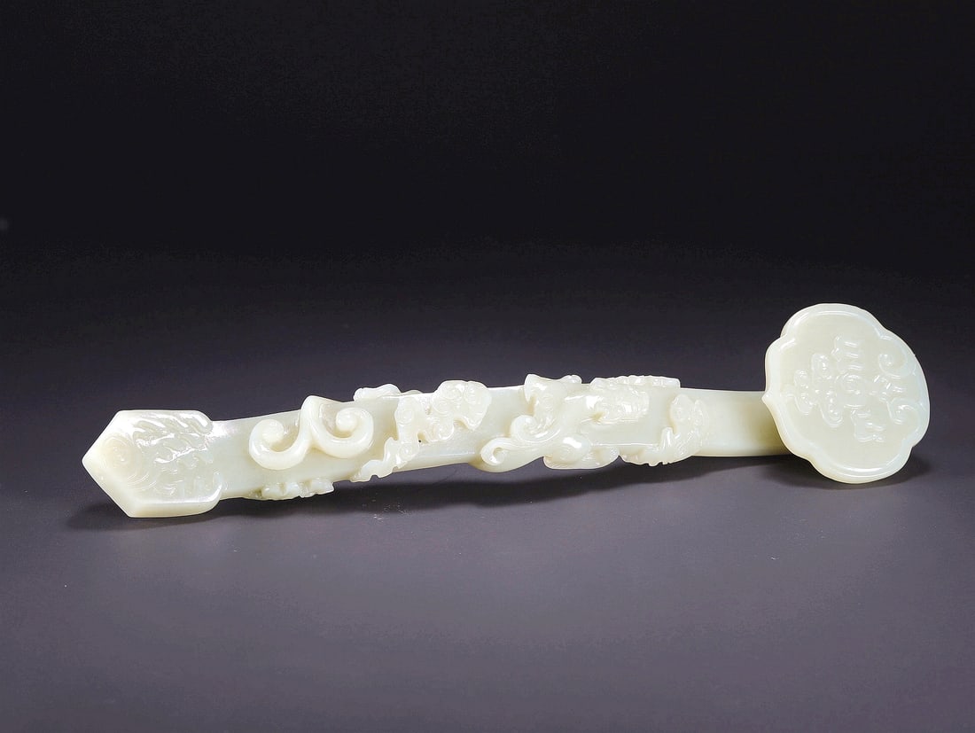 A HETIAN JADE RUYI SCEPTER WITH DRAGON MOTIFS: A HETIAN JADE RUYI SCEPTER WITH DRAGON MOTIFS Size:23.5*5.5* 2.7cm