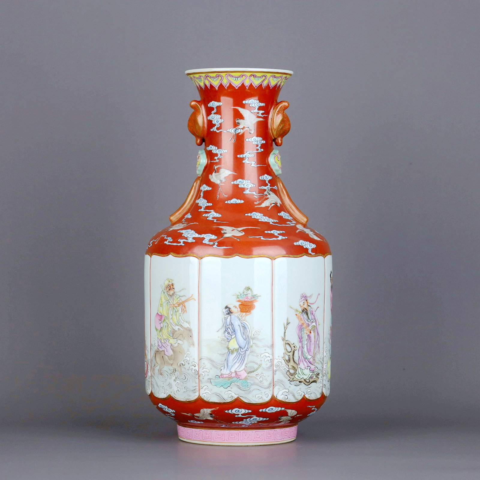 A IRON-RED-GROUND FAMILLE-ROSE CRANE AND EIGHT IMMORTALS DOUBLE-EAR VASE: A IRON-RED-GROUND FAMILLE-ROSE CRANE AND EIGHT IMMORTALS DOUBLE-EAR VASE Size:Height:34cm,Diam:17.5cm