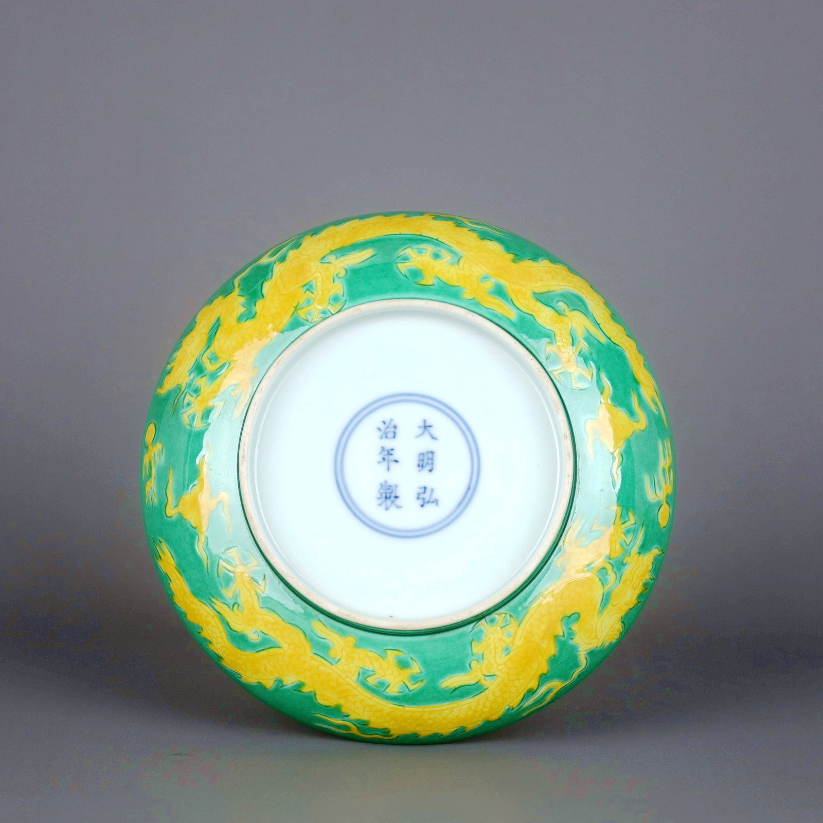 A GREEN GROUND YELLOW DRAGON DISH - 9