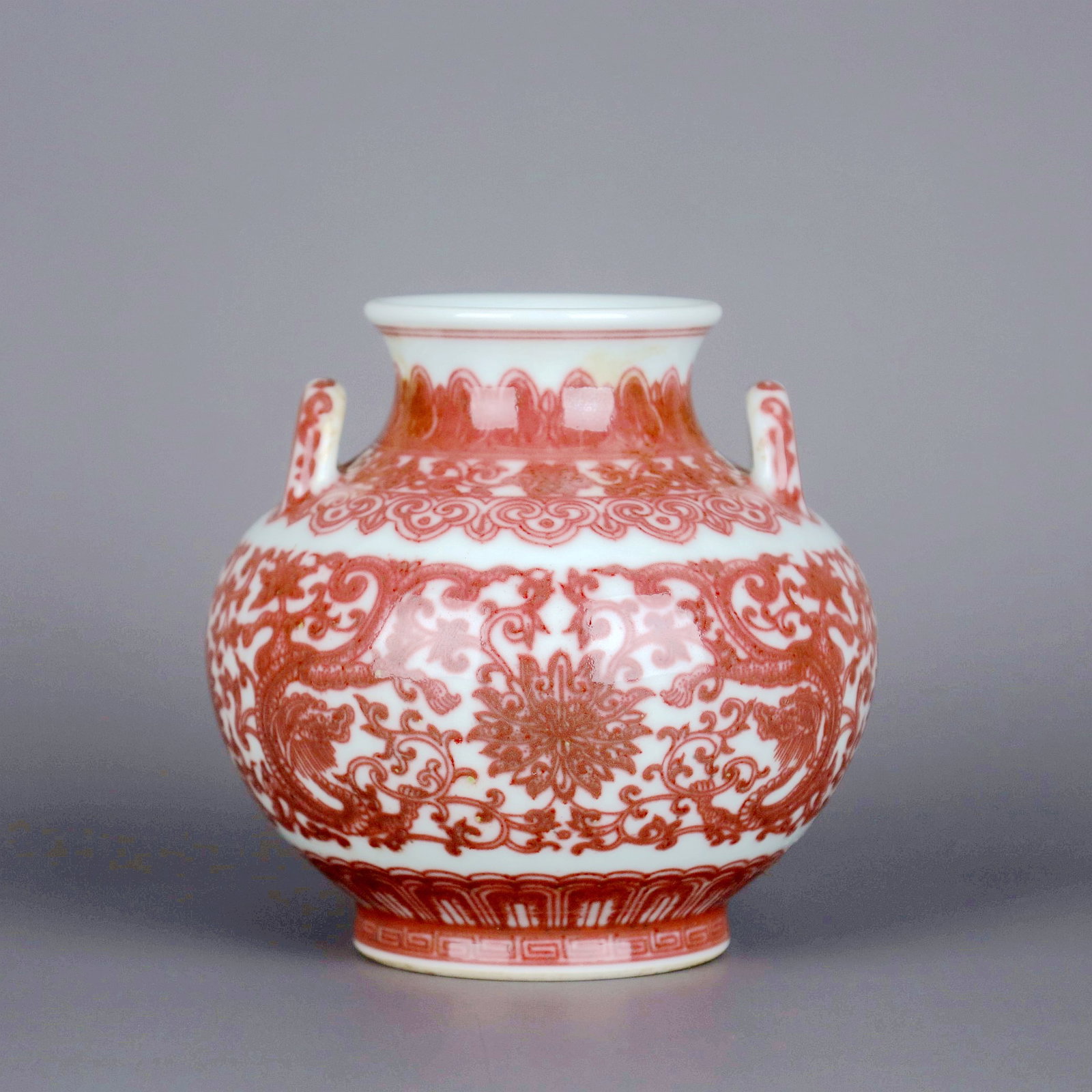 A COPPER-RED CHI DRAGON THROUGH LOTUS DOUBLE-EAR VASE,ZUN: A COPPER-RED CHI DRAGON THROUGH LOTUS DOUBLE-EAR VASE,ZUN Size:Height:10.6cm,Diam:10.8cm