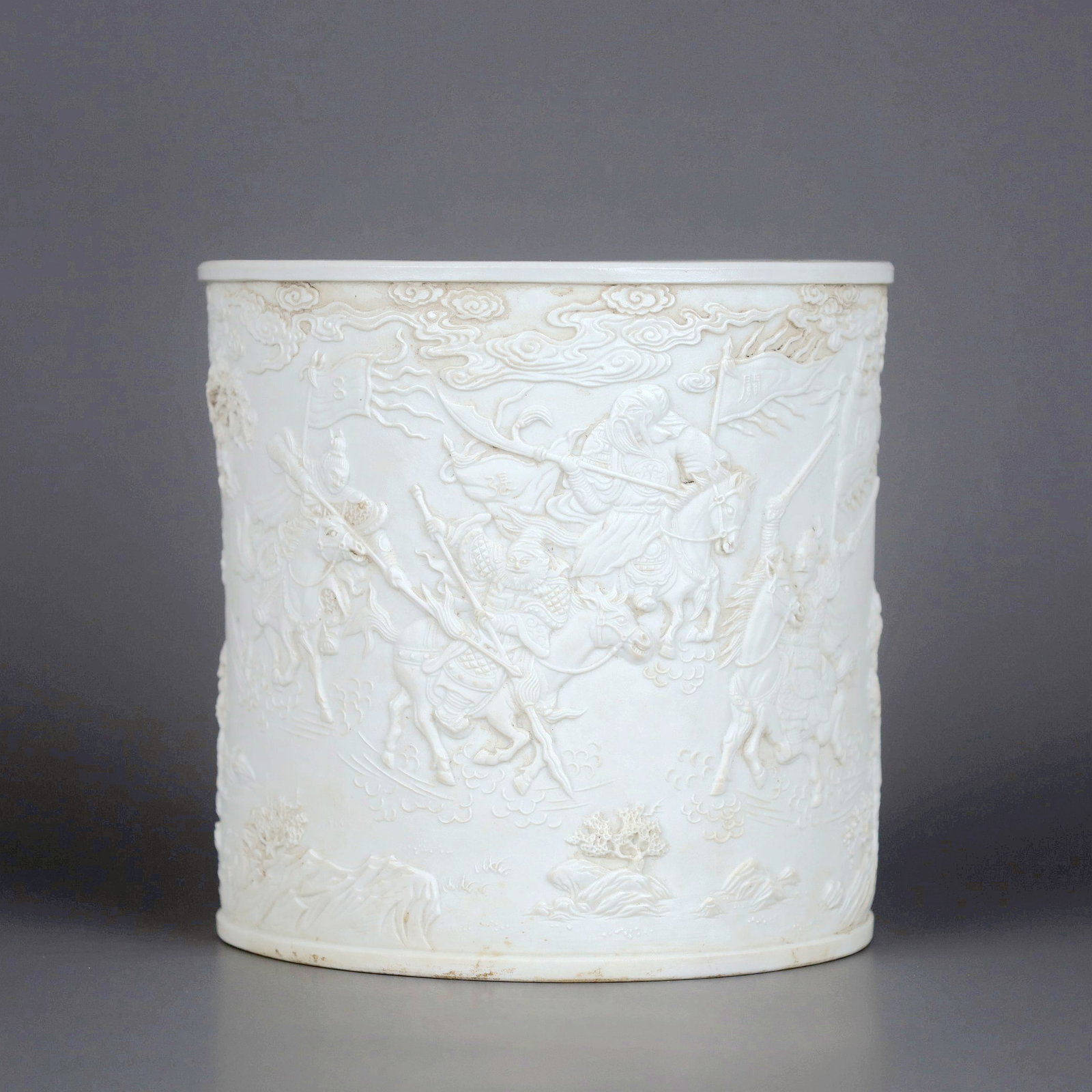 A WHITE PORCELAIN CARVED THREE KINGDOMS FIGURE BRUSHPOT (1 of 9)