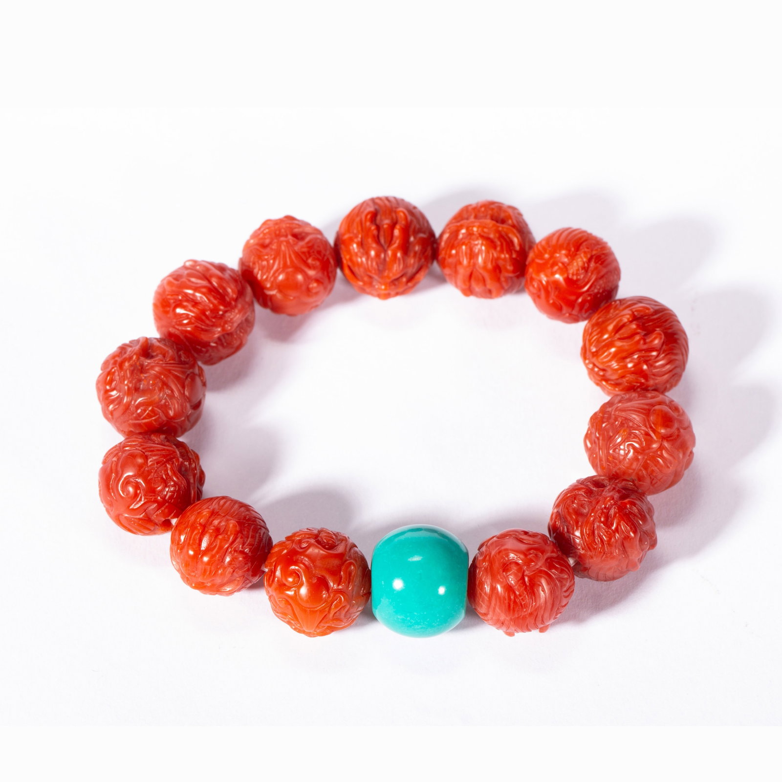 A CHINESE RED AGATE CARVED BEAD BRACELET (1 of 9)