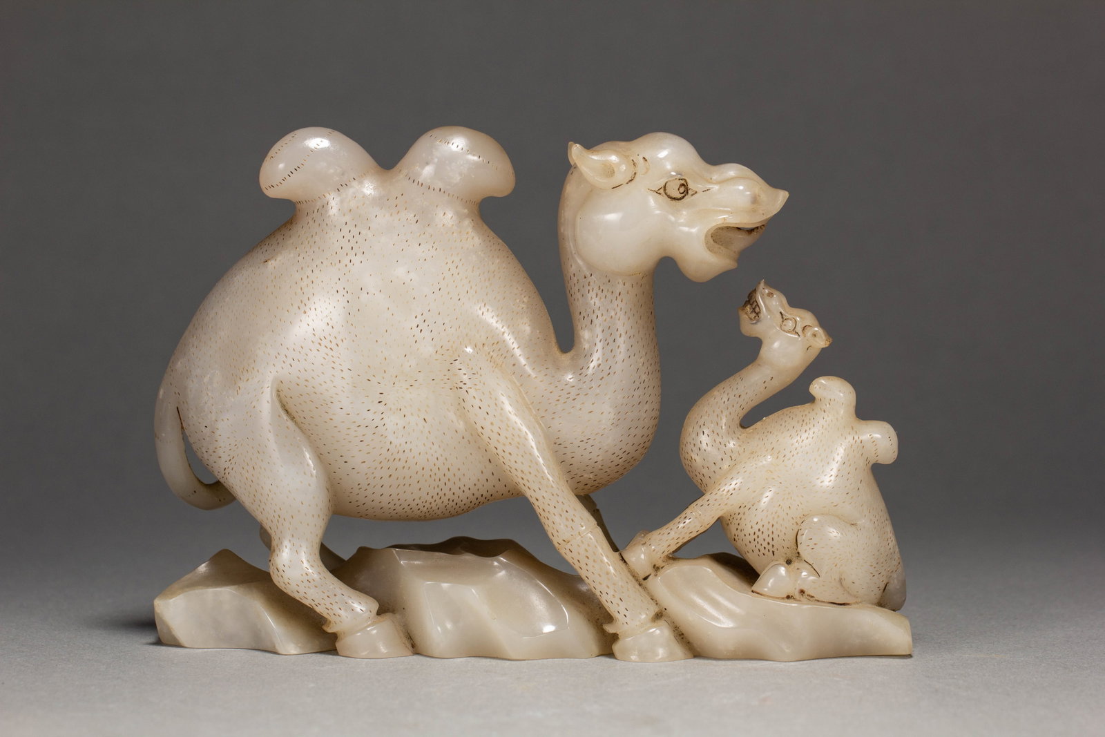 A CHINESE HETIAN JADE CAMEL AND CALF GROUP: A CHINESE HETIAN JADE CAMEL AND CALF GROUP (14.5 x 4.5 x 10cm,Weight 680g)