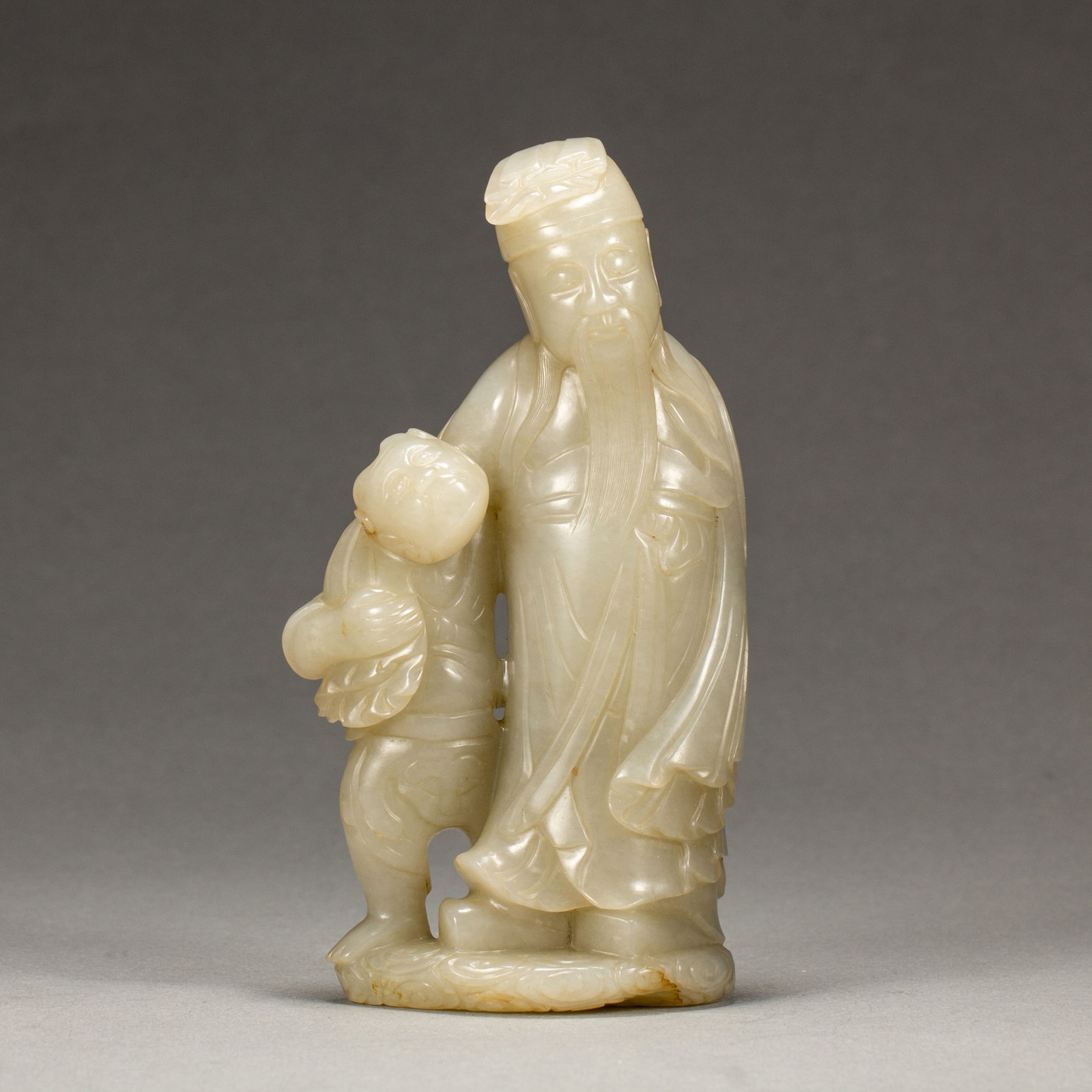 A CHINESE WHITE HETIAN JADE IMMORTAL AND BOY CARVING: A CHINESE WHITE HETIAN JADE IMMORTAL AND BOY CARVING (7.5 x 13.5cm,Weight 350g)