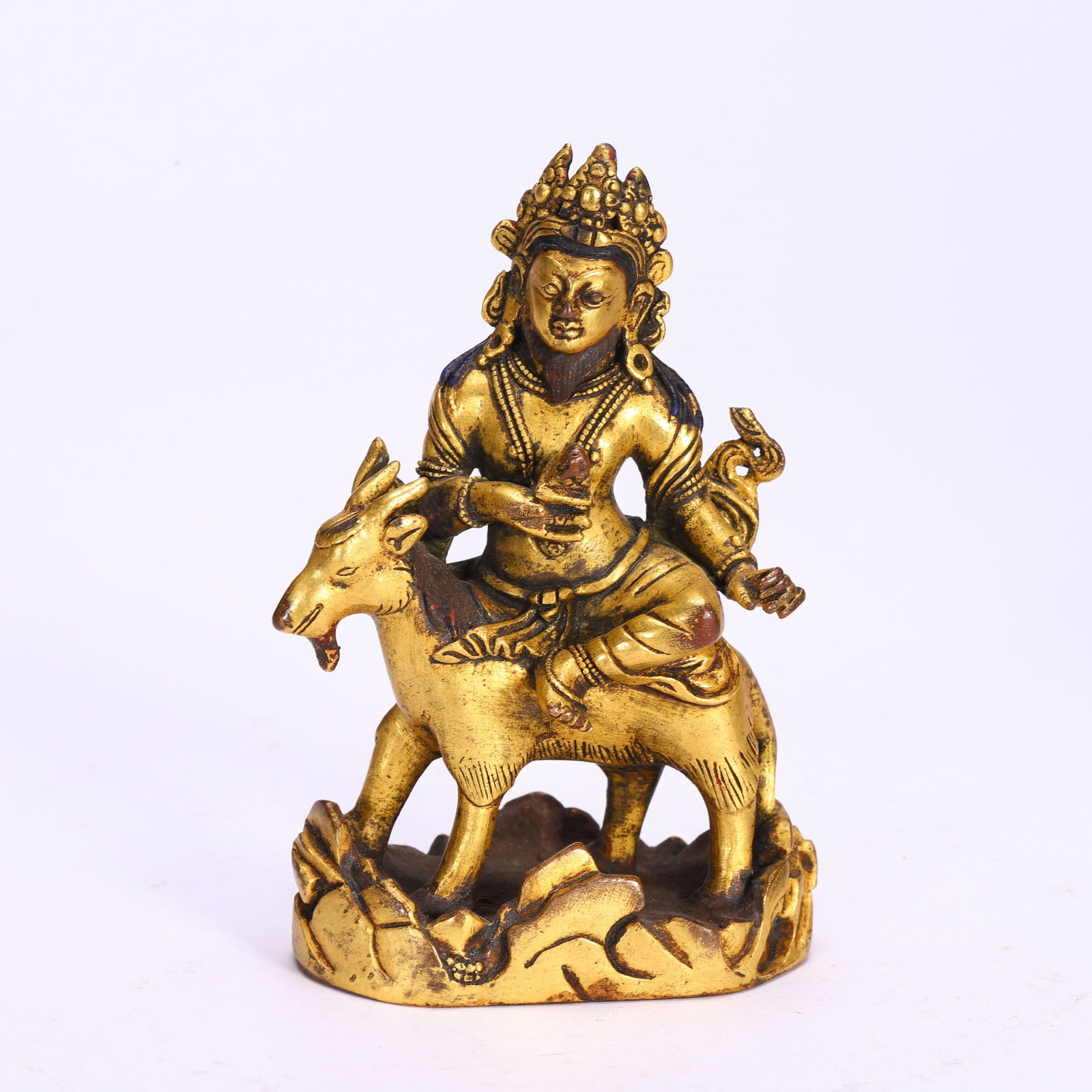 A CHINESE GILT BRONZE DEITY SEATED ON GOAT: A CHINESE GILT BRONZE DEITY SEATED ON GOAT (10cm,Weight 300g)