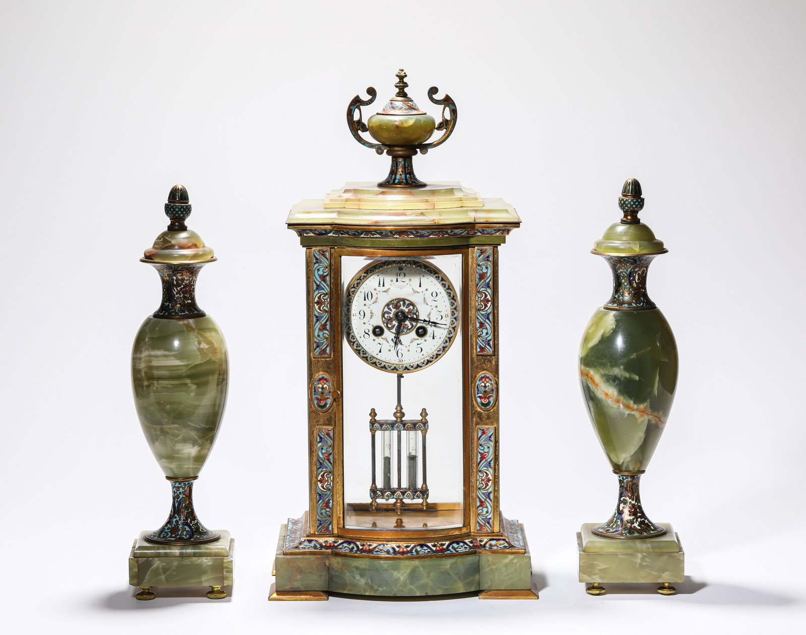 A GROUP OF GILT-BRONZE CLOISONNE ENAMEL MANTEL CLOCK AND CANDLEHOLDERS: A GROUP OF GILT-BRONZE CLOISONNE ENAMEL MANTEL CLOCK AND CANDLEHOLDERS Description: Dimensions: Weight: 8750 g. Length: 23.3 cm x Width: 16 cm x Height: 45 cm. Width: 8.9 cm x Height: 35 cm. All