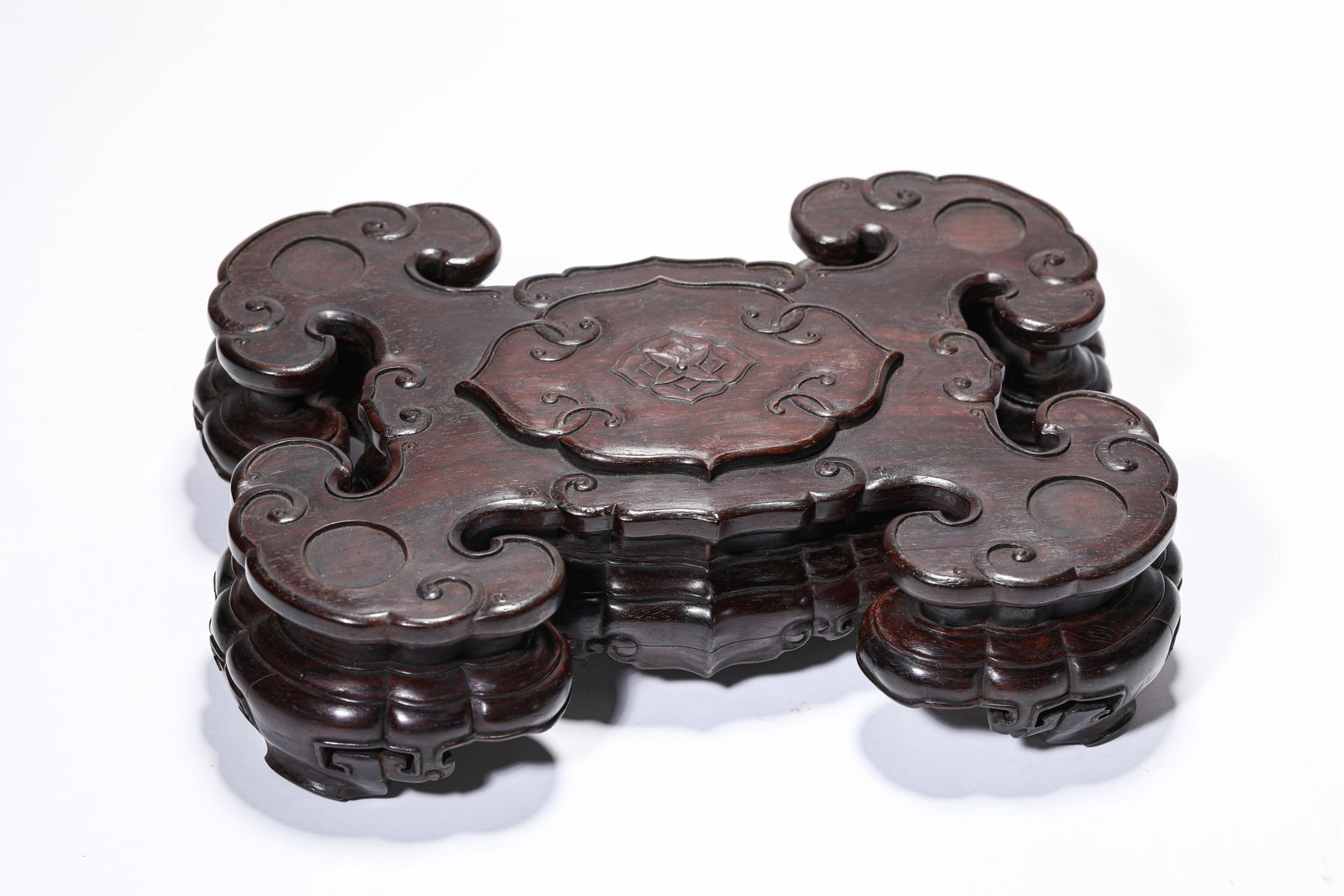 A WOODEN STAND: A WOODEN STAND Description: Dimensions: Length: 25.3 cm x Width: 19 cm x Height: 7 cm. All measurements are approximate.