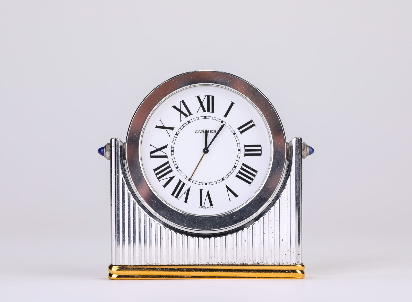 A CARTIER CARRIAGE CLOCK: A CARTIER CARRIAGE CLOCK Description: Dimensions: Weight: 406 g. Length: 8.1 cm x Width: 1.9 cm x Height: 7.7 cm. All measurements are approximate.