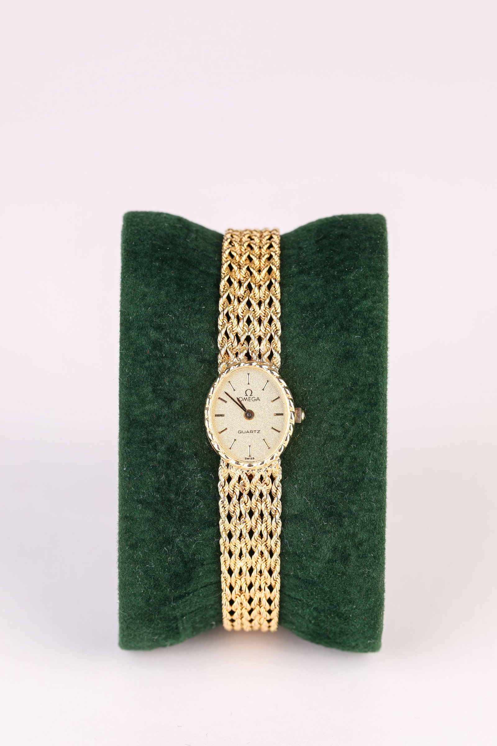 AN OMEGA GOLD AND DIAMOND WRISTWATCH: AN OMEGA GOLD AND DIAMOND WRISTWATCH Description: Dimensions: Width: 16 mm x Height: 18 mm. All measurements are approximate.