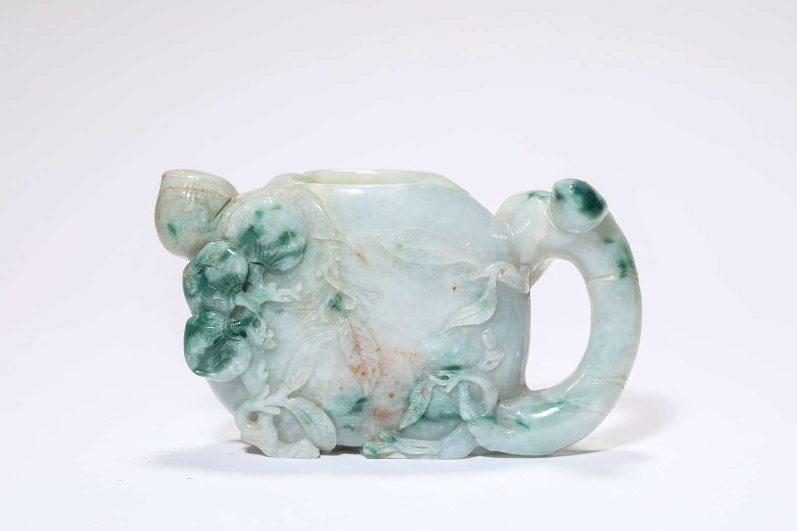 A JADEITE 'CARVED PEACH' WATER POT: A JADEITE 'CARVED PEACH' WATER POT Description: Dimensions: Length: 11.7 cm x Width: 3.7 cm x Height: 6.9 cm. All measurements are approximate.