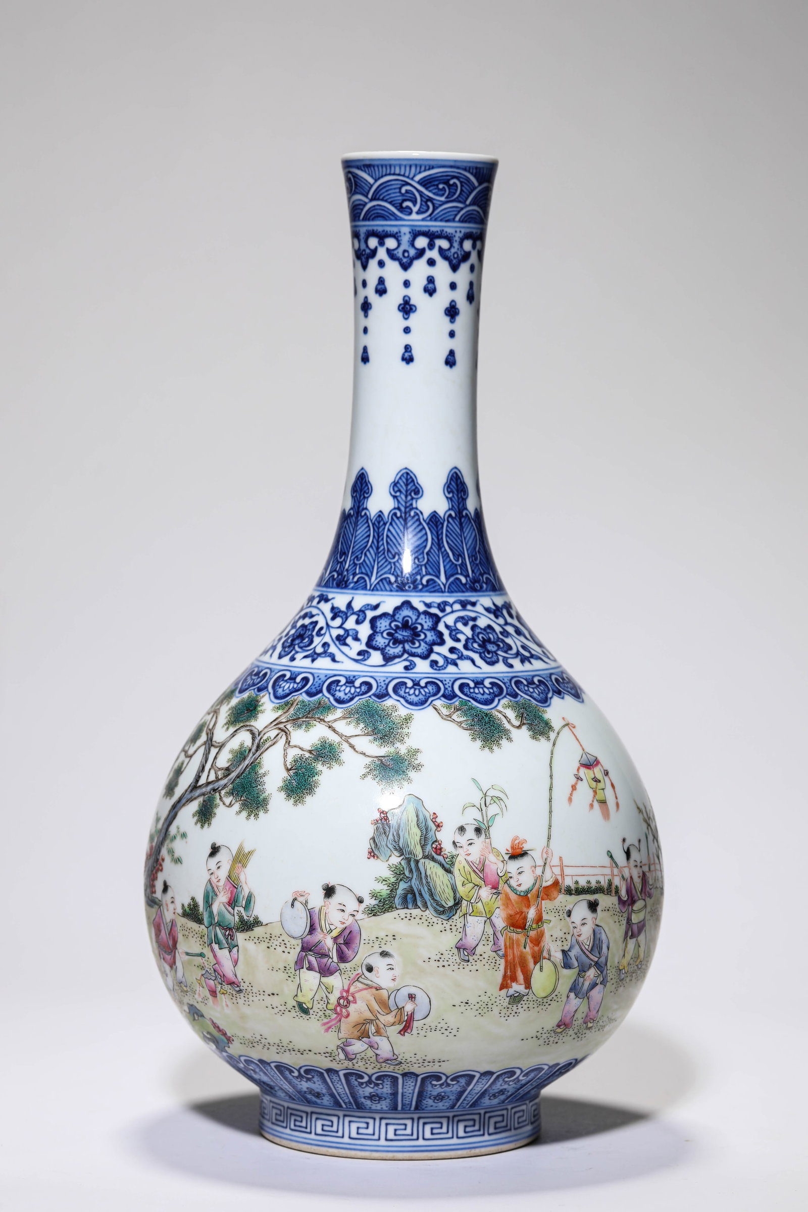 A BLUE AND WHITE AND FAMILLE-ROSE 'CHILDREN AT PLAY' LONG-NECK VASE: A BLUE AND WHITE AND FAMILLE-ROSE 'CHILDREN AT PLAY' LONG-NECK VASE Description: Dimensions: Width: 18.7 cm x Height: 35.2 cm. All measurements are approximate.