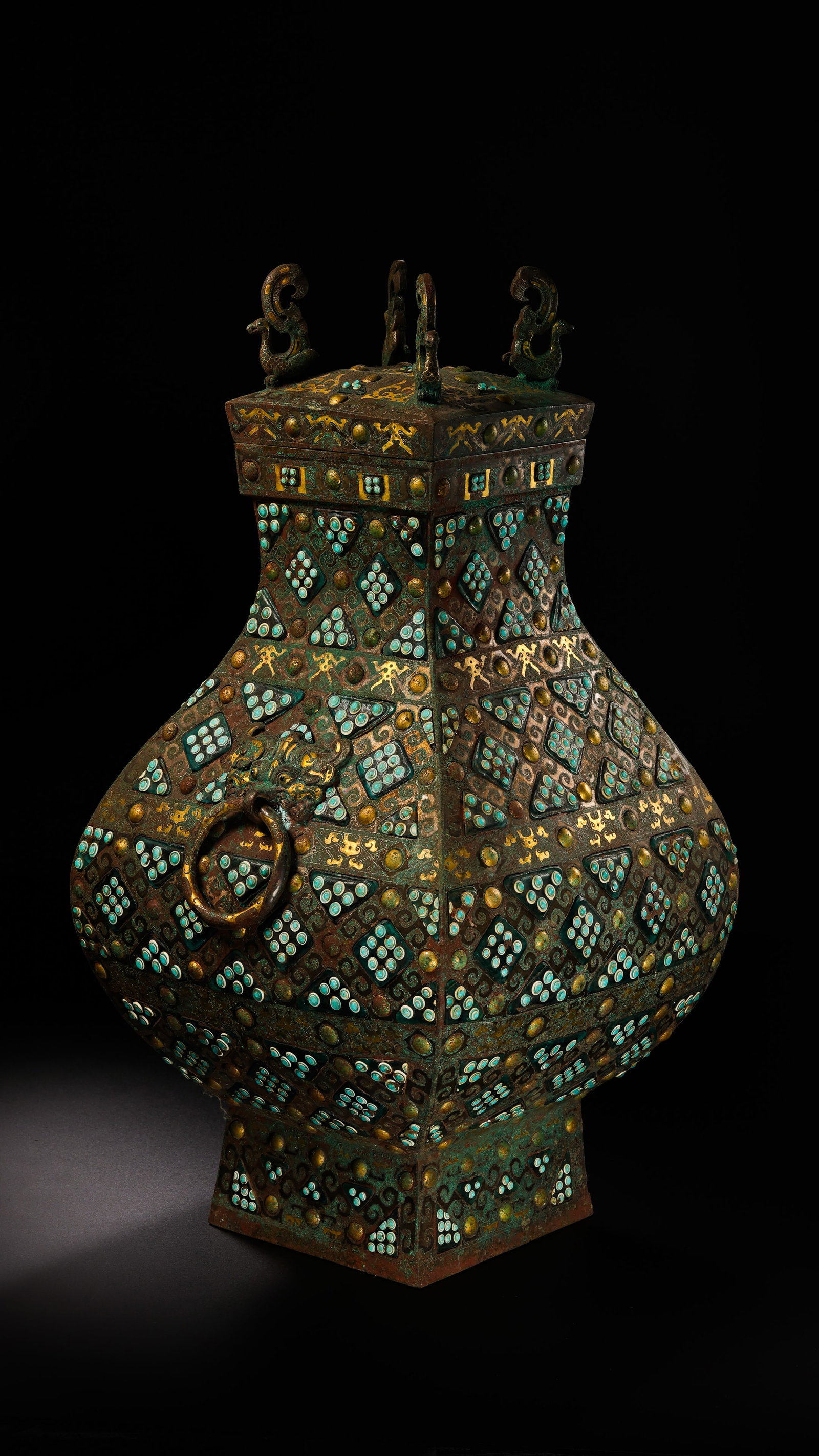 A GOLD AND SILVER-INLAID BRONZE COVERED VASE: A GOLD AND SILVER-INLAID BRONZE COVERED VASE Description: Dimensions: Width: 22 cm x Height: 47 cm. All measurements are approximate.