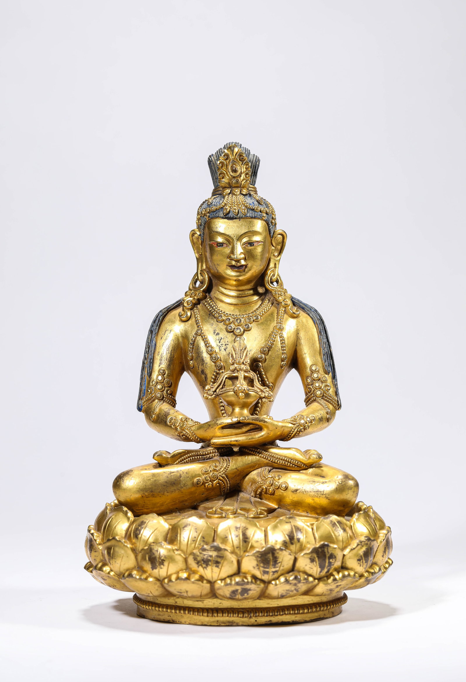 A GILT-BRONZE FIGURE OF AMITAYUS: A GILT-BRONZE FIGURE OF AMITAYUS Description: Dimensions: Weight: 3355 g. Length: 16.3 cm x Width: 15 cm x Height: 25.5 cm. All measurements are approximate.