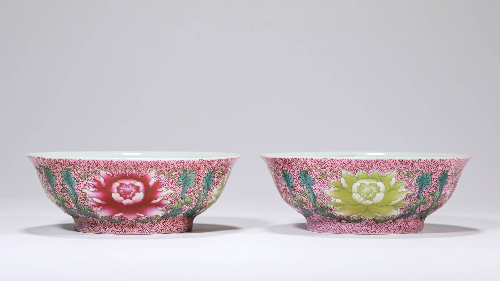 A PAIR OF ROUGE-GROUND FAMILLE-ROSE 'FLORAL' BOWLS: A PAIR OF ROUGE-GROUND FAMILLE-ROSE 'FLORAL' BOWLS Description: Dimensions: Width: 11.9 cm x Height: 4.2 cm. All measurements are approximate.