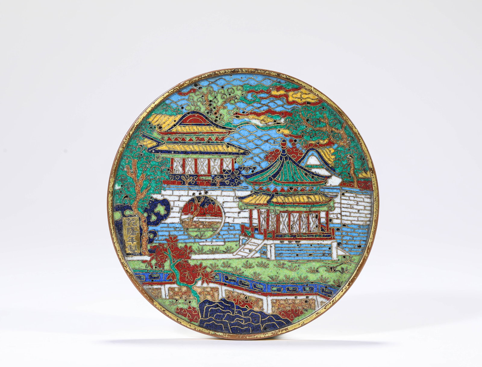 A CLOISONNE ENAMEL 'PAVILIONS AND TERRACES' BRONZE MIRROR: A CLOISONNE ENAMEL 'PAVILIONS AND TERRACES' BRONZE MIRROR Description: Dimensions: Weight: 247 g. Width: 9.6 cm x Height: 0.5 cm. All measurements are approximate.