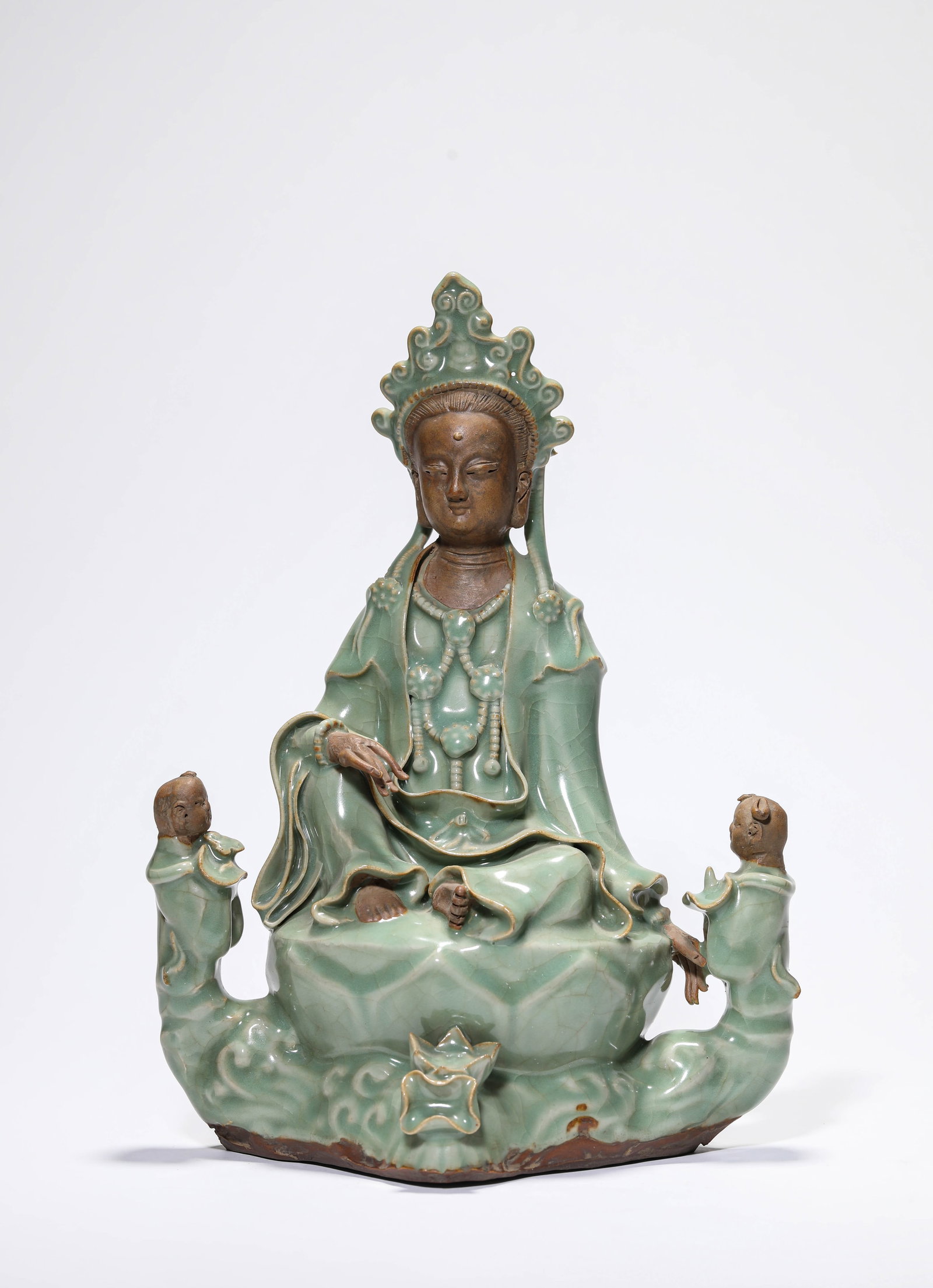A LONGQUAN-TYPE FIGURE OF GUANYIN WITH CHILD: A LONGQUAN-TYPE FIGURE OF GUANYIN WITH CHILD Description: Dimensions: Length: 20.4 cm x Width: 12.2 cm x Height: 28.4 cm. All measurements are approximate.