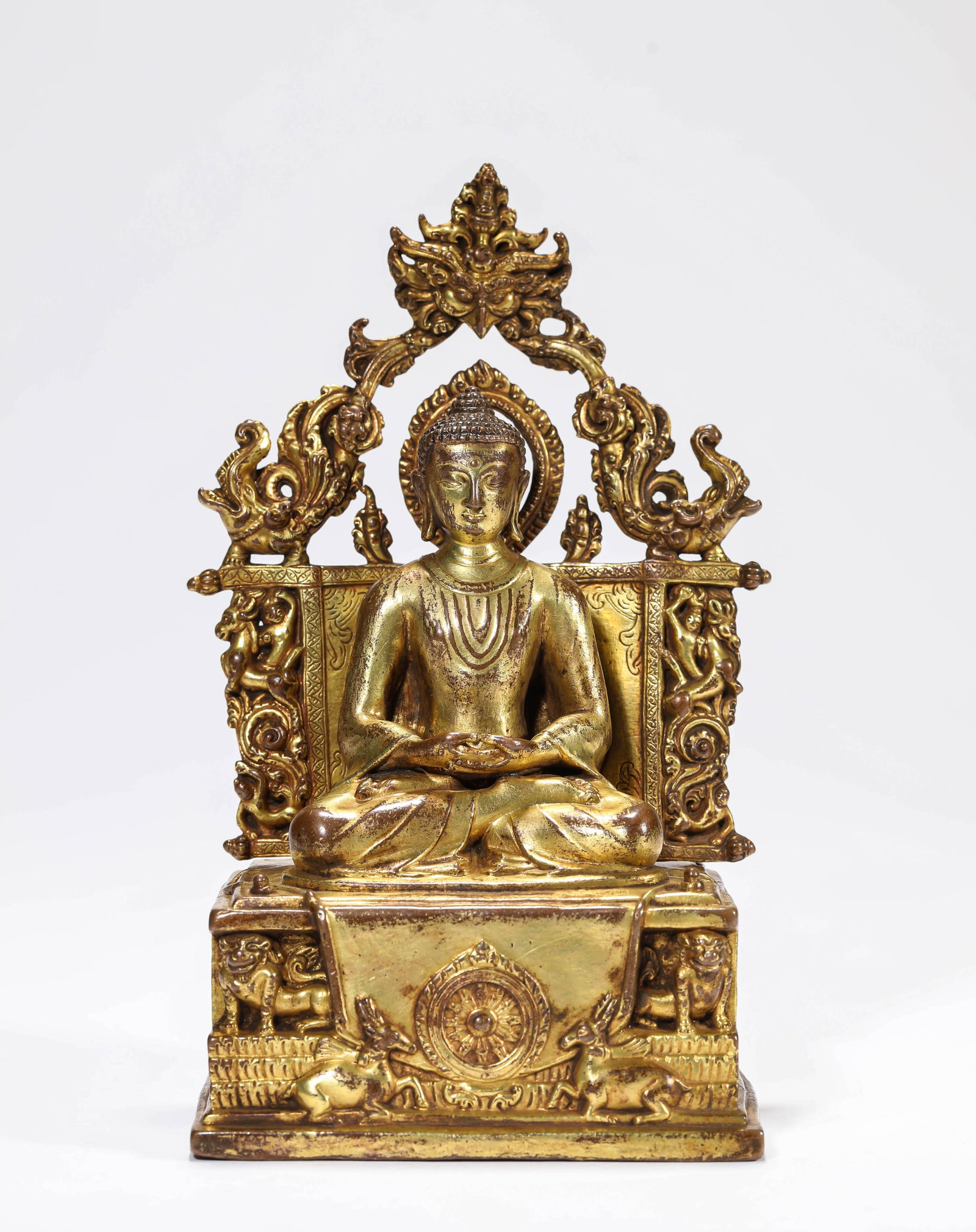 A GILT-BRONZE FIGURE OF SHAKYAMUNI: A GILT-BRONZE FIGURE OF SHAKYAMUNI Description: Dimensions: Weight: 1147 g. Length: 11.1 cm x Width: 7 cm x Height: 17.8 cm. All measurements are approximate.