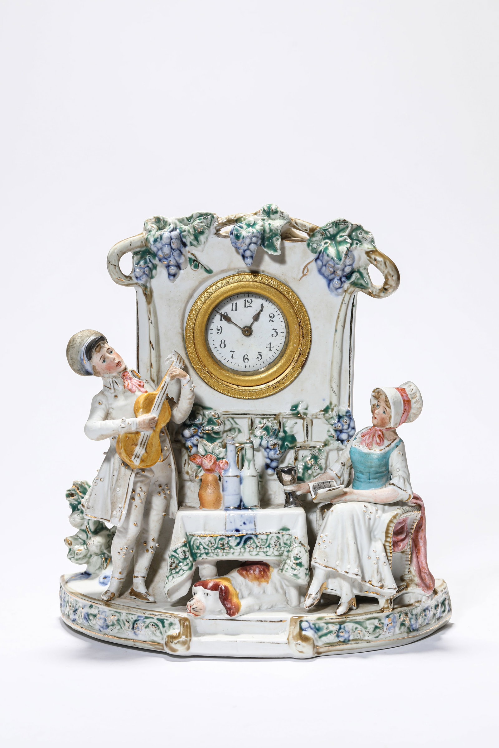 A PORCELAIN FIGURE MANTEL CLOCK: A PORCELAIN FIGURE MANTEL CLOCK Description: Dimensions: Length: 23.2 cm x Width: 12.5 cm x Height: 35 cm. All measurements are approximate.