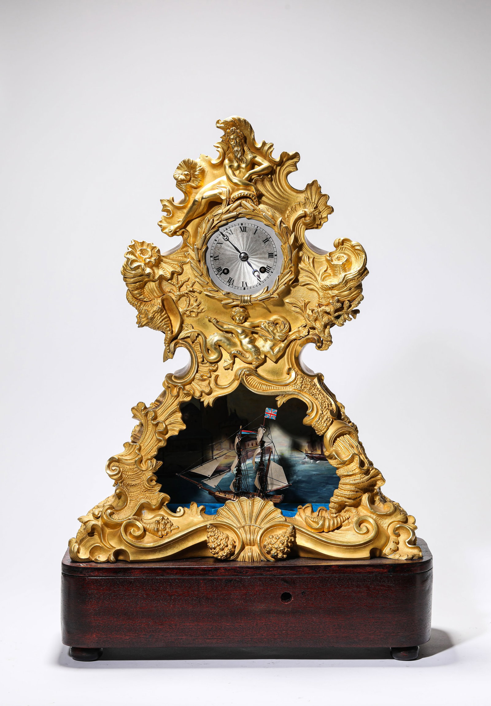 A GILT-BRONZE AUTOMATON CLOCK: A GILT-BRONZE AUTOMATON CLOCK Description: Dimensions: Weight: 9750 g. Length: 37 cm x Width: 17.3 cm x Height: 54.5 cm. All measurements are approximate.