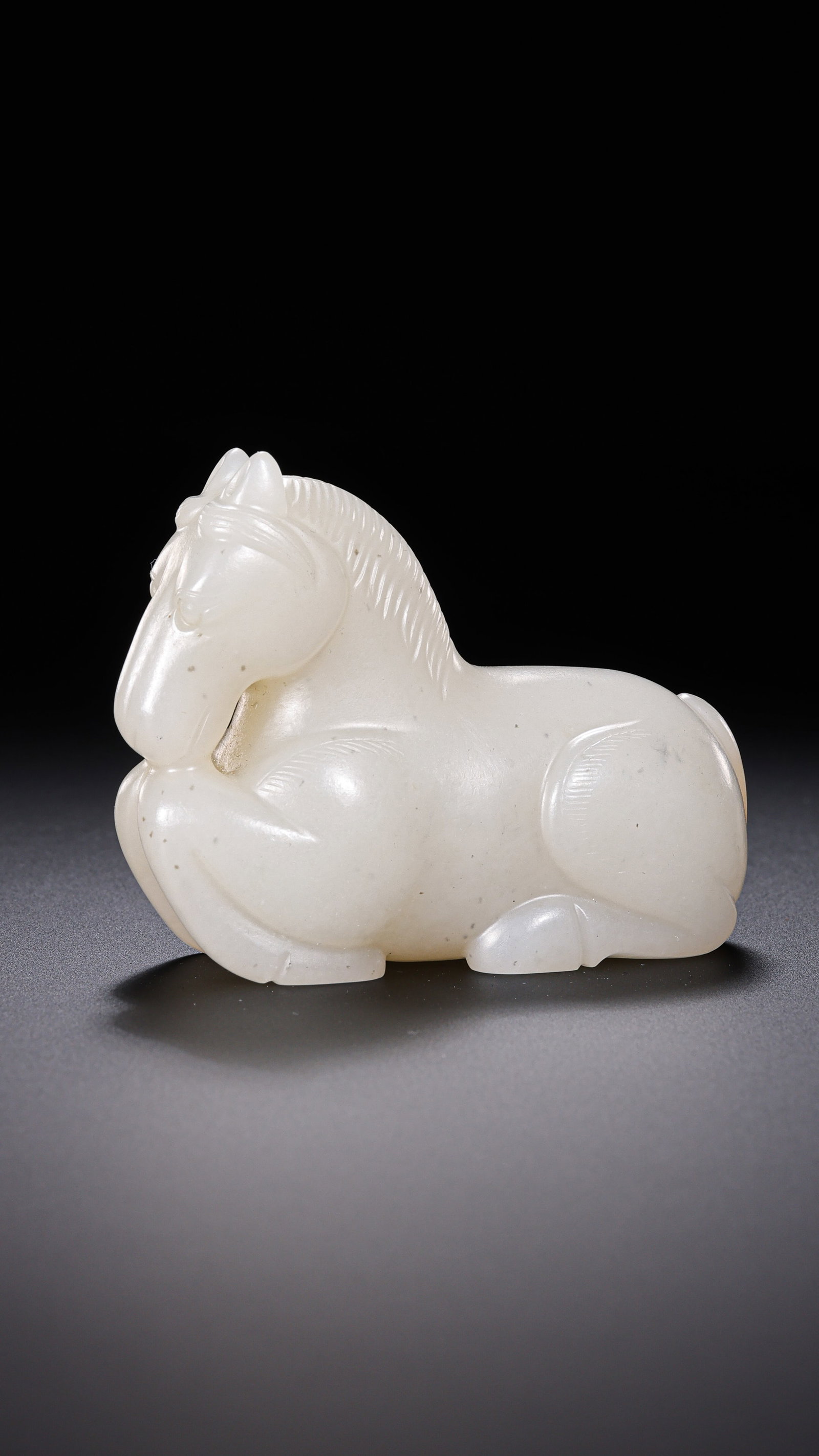 A JADE RECUMBENT HORSE: A JADE RECUMBENT HORSE Description: Dimensions: Width: 6 cm x Height: 4.5 cm. All measurements are approximate.