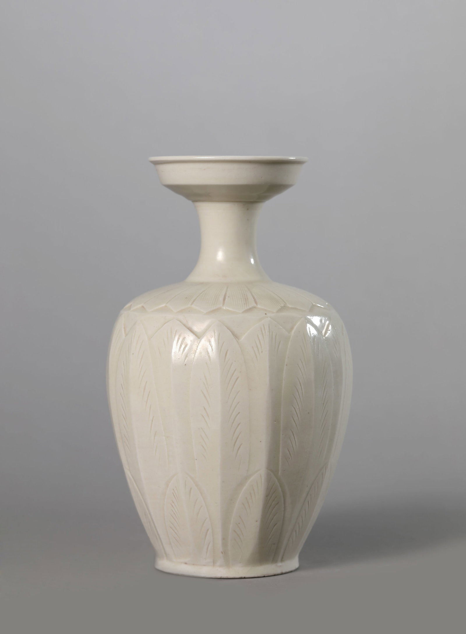A DING TYPE CARVED PLANTAIN LEAF VASE: A DING TYPE CARVED PLANTAIN LEAF VASE Description: Dimensions: Width: 11.3 cm x Height: 18.9 cm. All measurements are approximate.