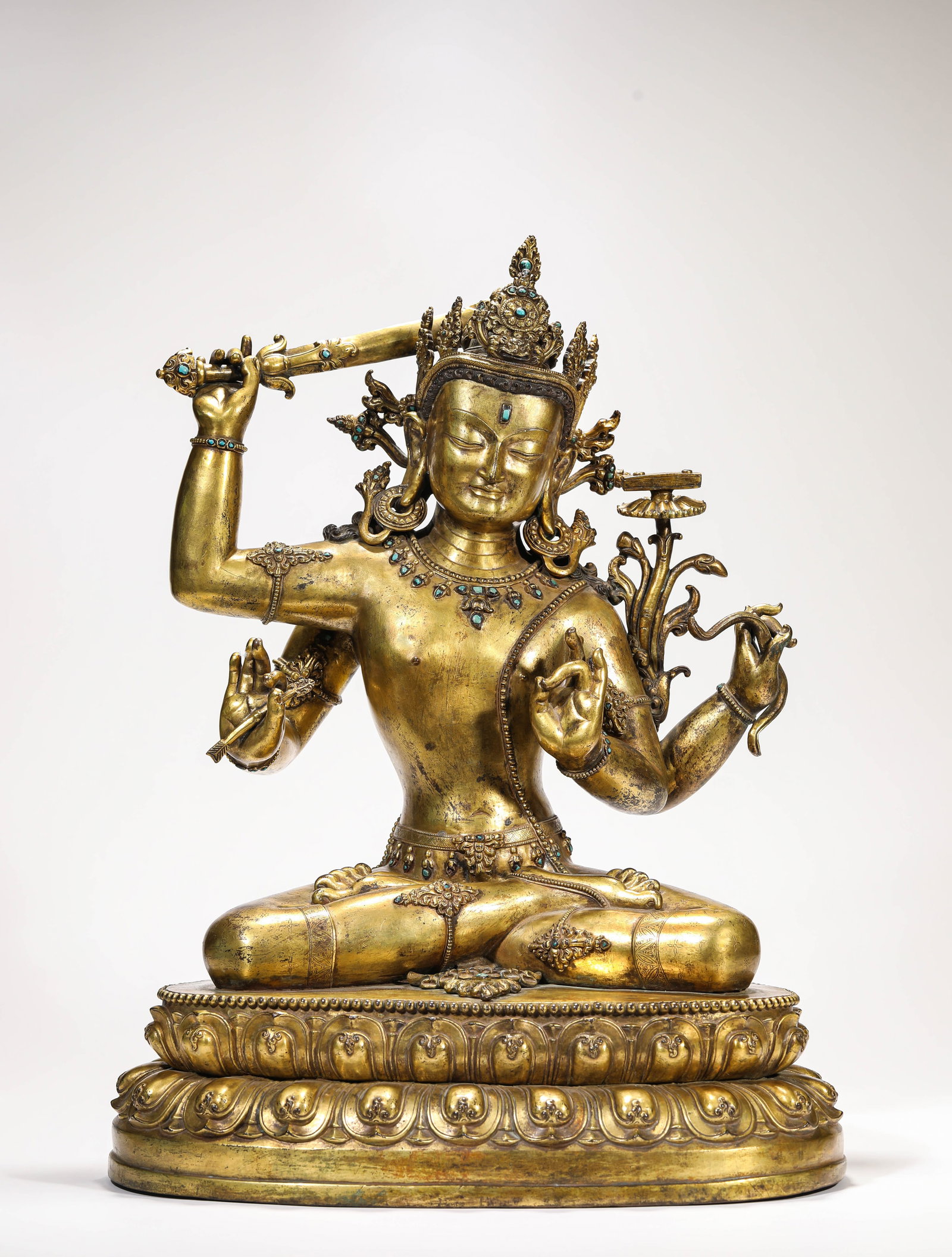 A GILT-BRONZE FIGURE OF FOUR-ARMED AVALOKITESHVARA: A GILT-BRONZE FIGURE OF FOUR-ARMED AVALOKITESHVARA Description: Dimensions: Weight: 14000 g. Length: 35.5 cm x Width: 26.5 cm x Height: 47.5 cm. All measurements are approximate.