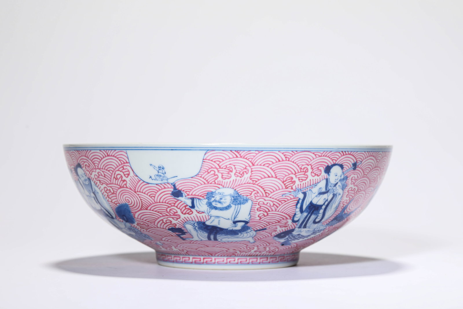 A BLUE AND WHITE AND ROUGE 'EIGHT IMMORTALS CROSSING THE SEA' BOWL: A BLUE AND WHITE AND ROUGE 'EIGHT IMMORTALS CROSSING THE SEA' BOWL Description: Dimensions: Width: 22.2 cm x Height: 8 cm. All measurements are approximate.
